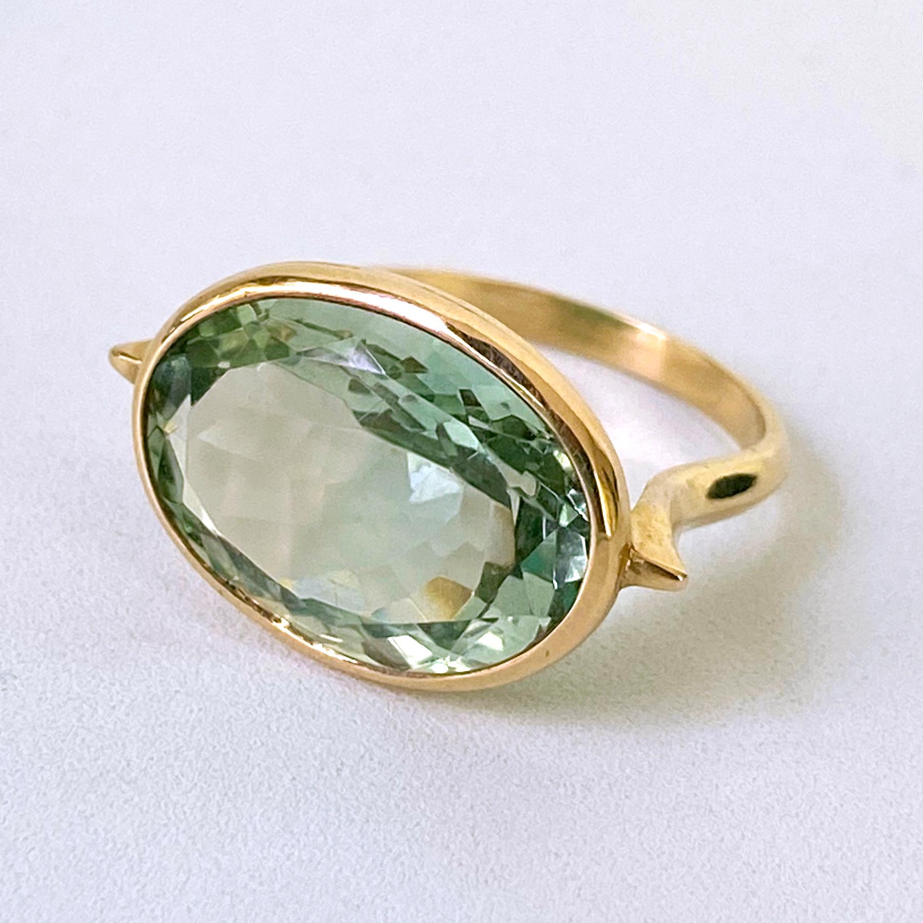 Gorgeous ring featuring a faceted oval 11c Green Amethyst stone - bezel set in 3 grams of solid 14k Yellow Gold. Ring interior is stamped 14k and is sized at 7.5 women's. Beautiful piece that flashes soft hues of Greens due to its perfect