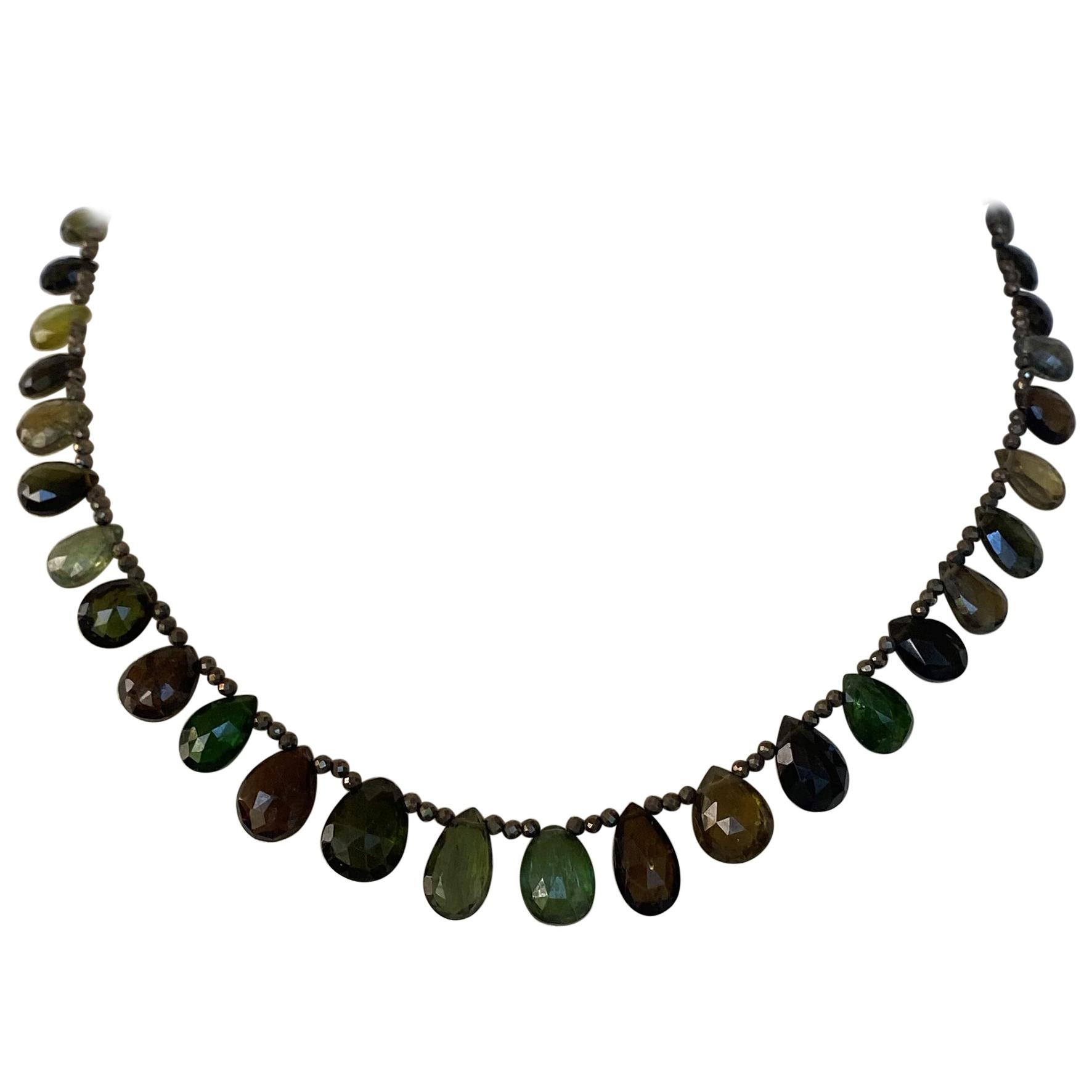 
Faceted Brown and Green Spinel beads decorated with faceted/ multi-colored/ teardrop Green Tourmaline briolettes that graduate in size. This necklace is secured with a sterling silver clasp and measures 16 inches long, that provides an elegant and