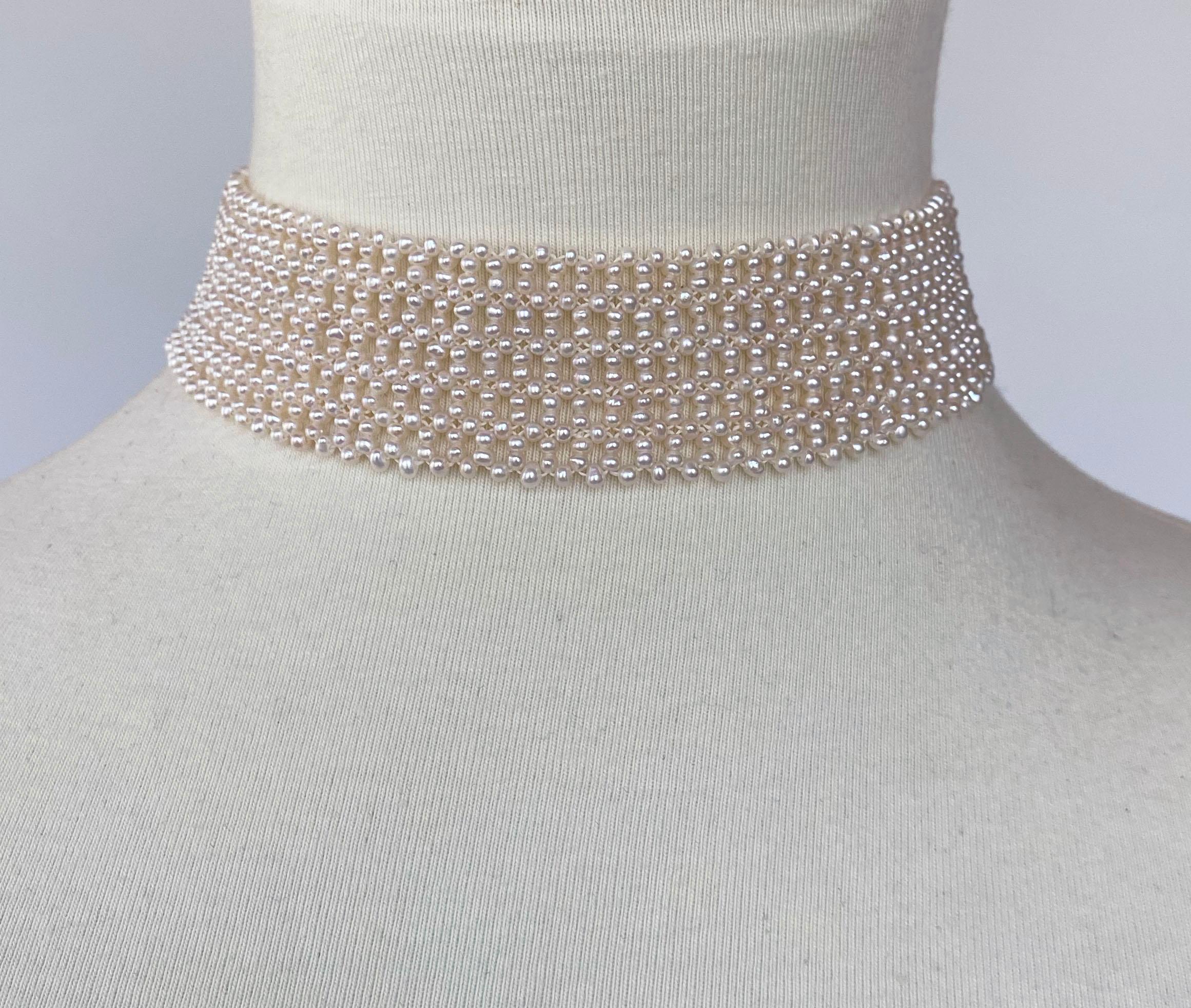 This elegant white seed pearl choker was woven with 1.5mm pearls. The intricately hand-woven piece has a delicate lace-like design. The choker is 1.25 inch wide and 13.5 inches long. The sturdy sliding silver clasp is gold plated . This piece can