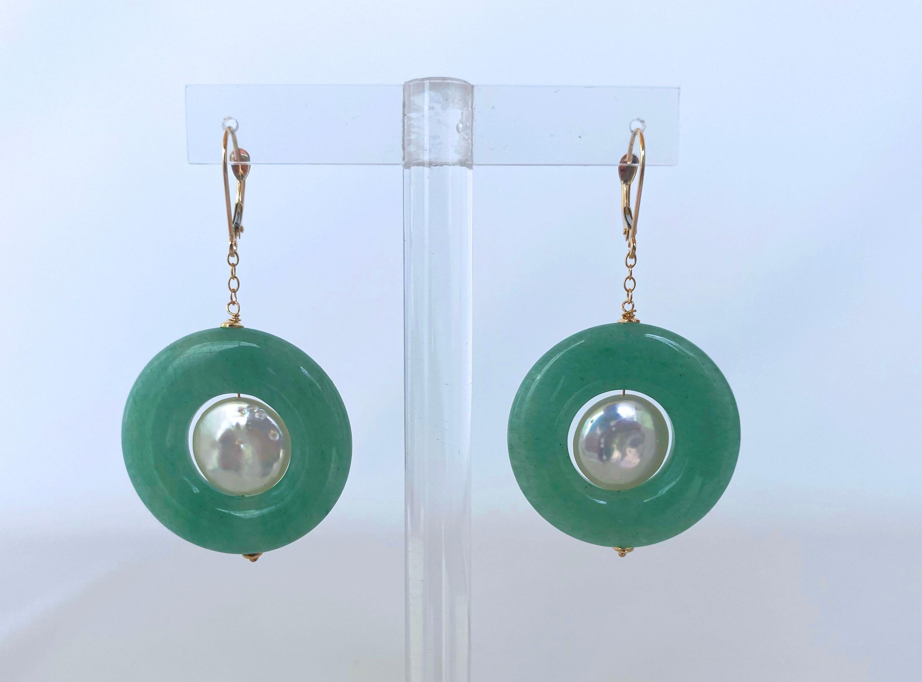 This pair of earrings features gorgeous high luster coin Pearls dangling within beautiful Jade beads. Made with a 14K Yellow Gold chain and Lever Back Hooks for the upmost comfortable and perfect wear. Measuring at 2.25 inches long, this pair offer