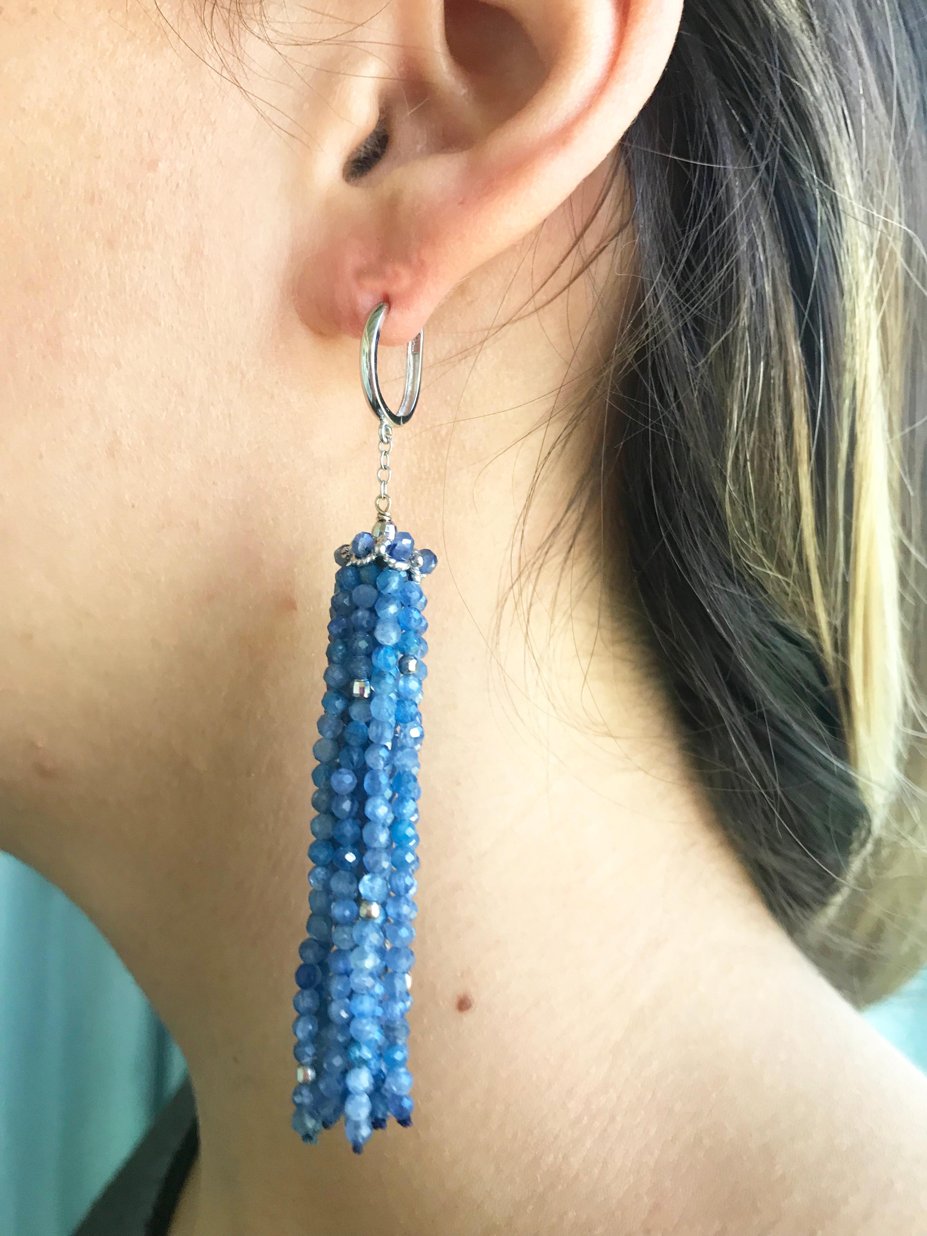 These whimsical earrings are made with kyanite beads. They are accented with a gracefully designed of 14k white gold cups that highlights the blue tone of the tassel. At 3 inches long the tassels flow beautifully in time with movement. The 14 karats
