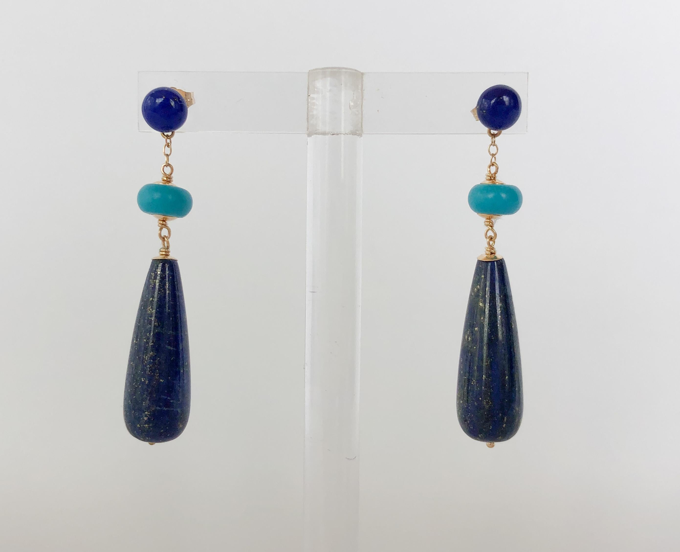 These eye-catching earrings are a combination of studs and dangle earrings. The stud is made with a lapis lazuli bead, and attached to it is a turquoise bead and long lapis lazuli bead. The wiring and earring post are made of 14k gold and have a