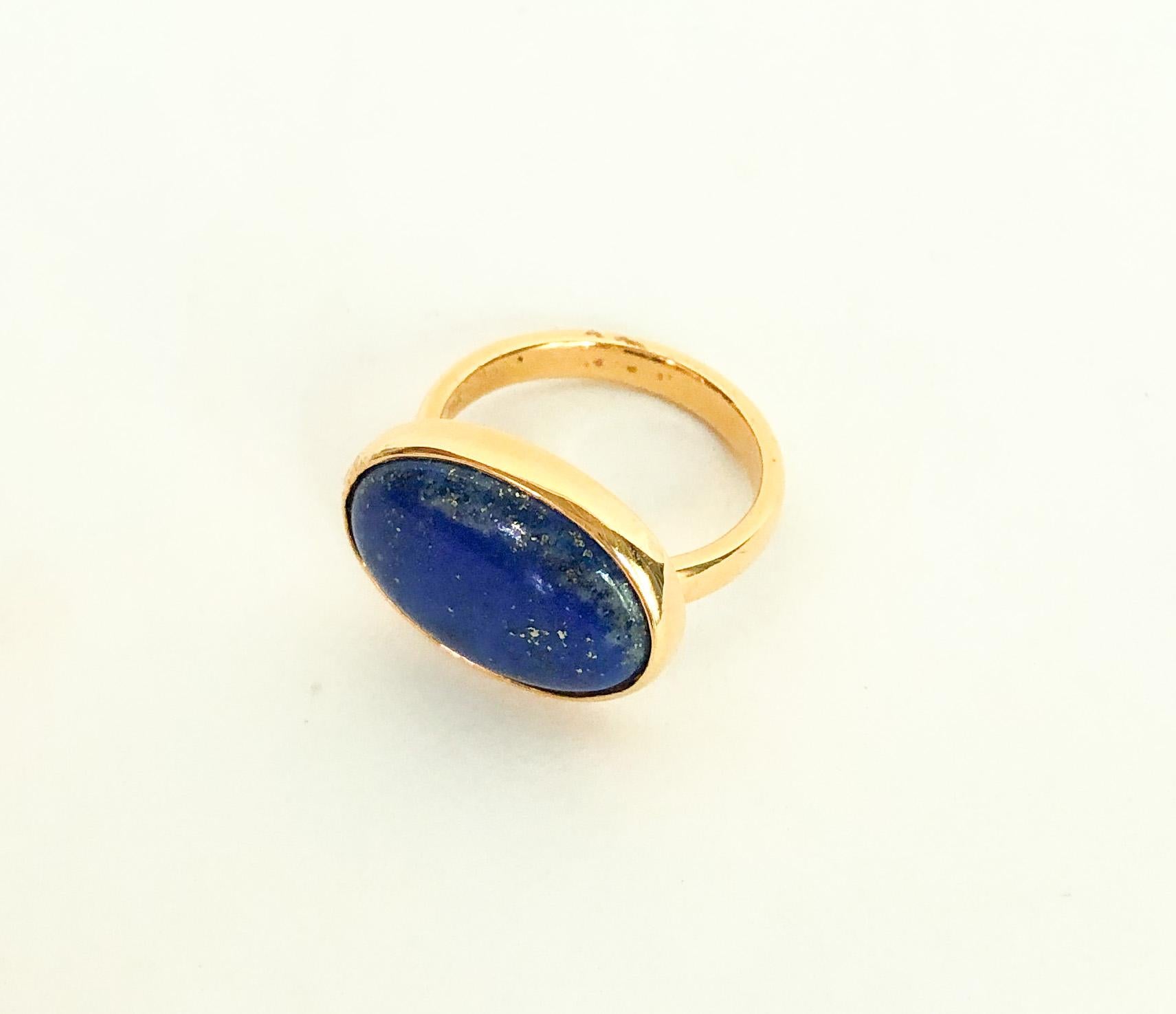 Beautiful ring by Marina J. This ring features a domed Lapis Lazuli stone perfectly bezel set in solid 14k Yellow Gold (weighing roughly 4.5 grams of solid 14k Gold). The stone's stunning Royal Blue color is perfectly accented by the Gold, giving a