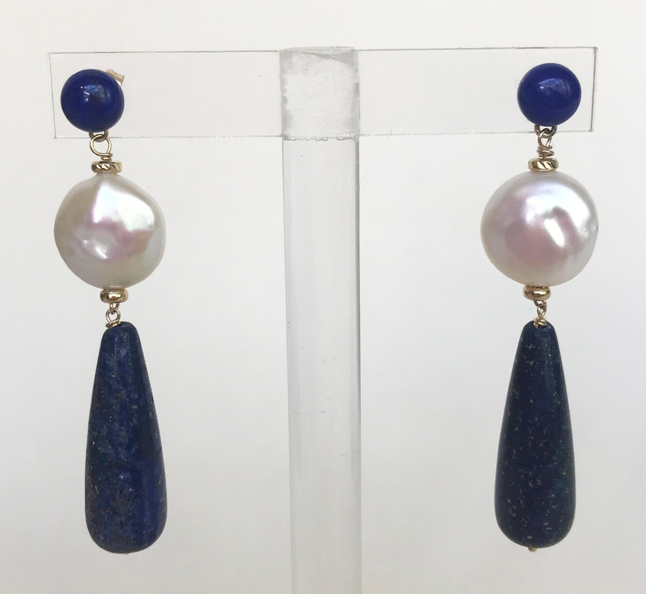 Marina J. stunning collection presents this new wonderful piece made from a 14k yellow gold wiring and stud. The stud showcase an elegant lapis lazuli bead  with a 14k yellow gold rondel on top of a pearl coin. To finish the look, a lapis lazuli