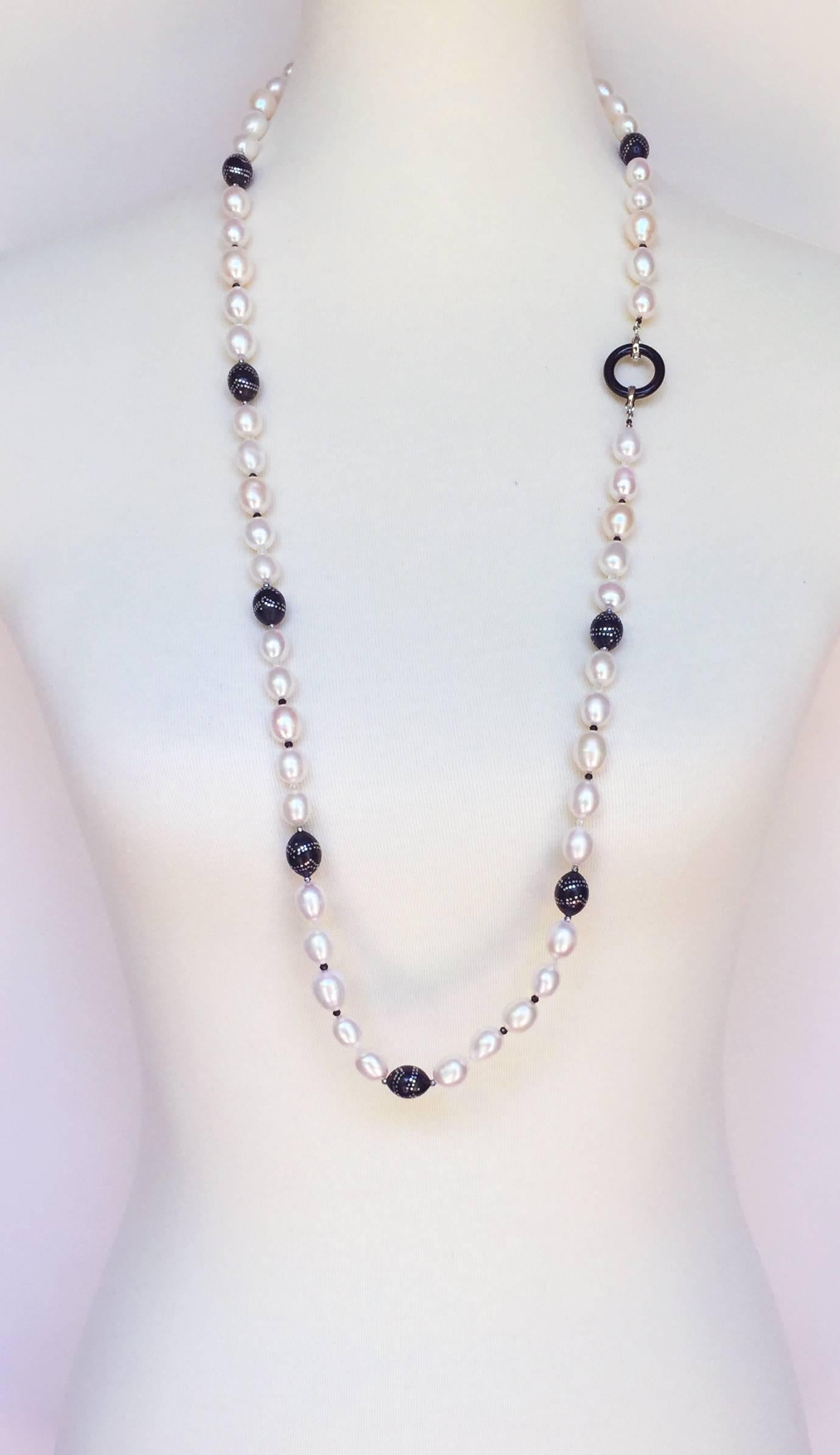 This necklace is made of large oval pearls accented with handmade antique wooden beads with silver inlay. The removable tassel stands out with a large pearl sitting on a diamond encrusted rhondel and onyx rhondel, with graduated fine pearls