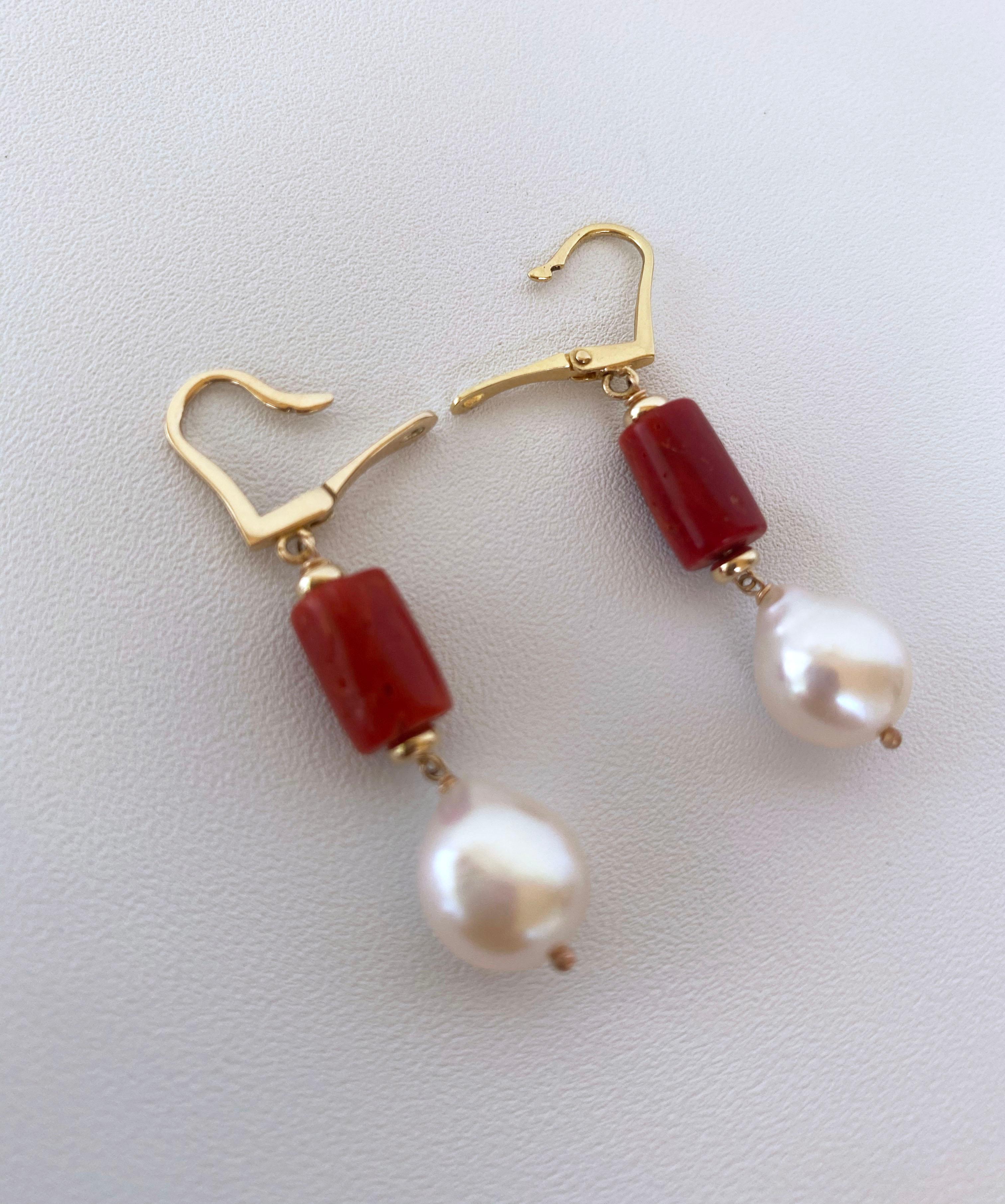 Beautiful and simple pair of earrings hand made by Marina J. This pair features high shine 14K Yellow Gold Lever Back Hooks, allow upmost comfort on the ear. Dangling beneath is a cylindrical deep Red/Orange Mediterranean Coral bead, perfectly