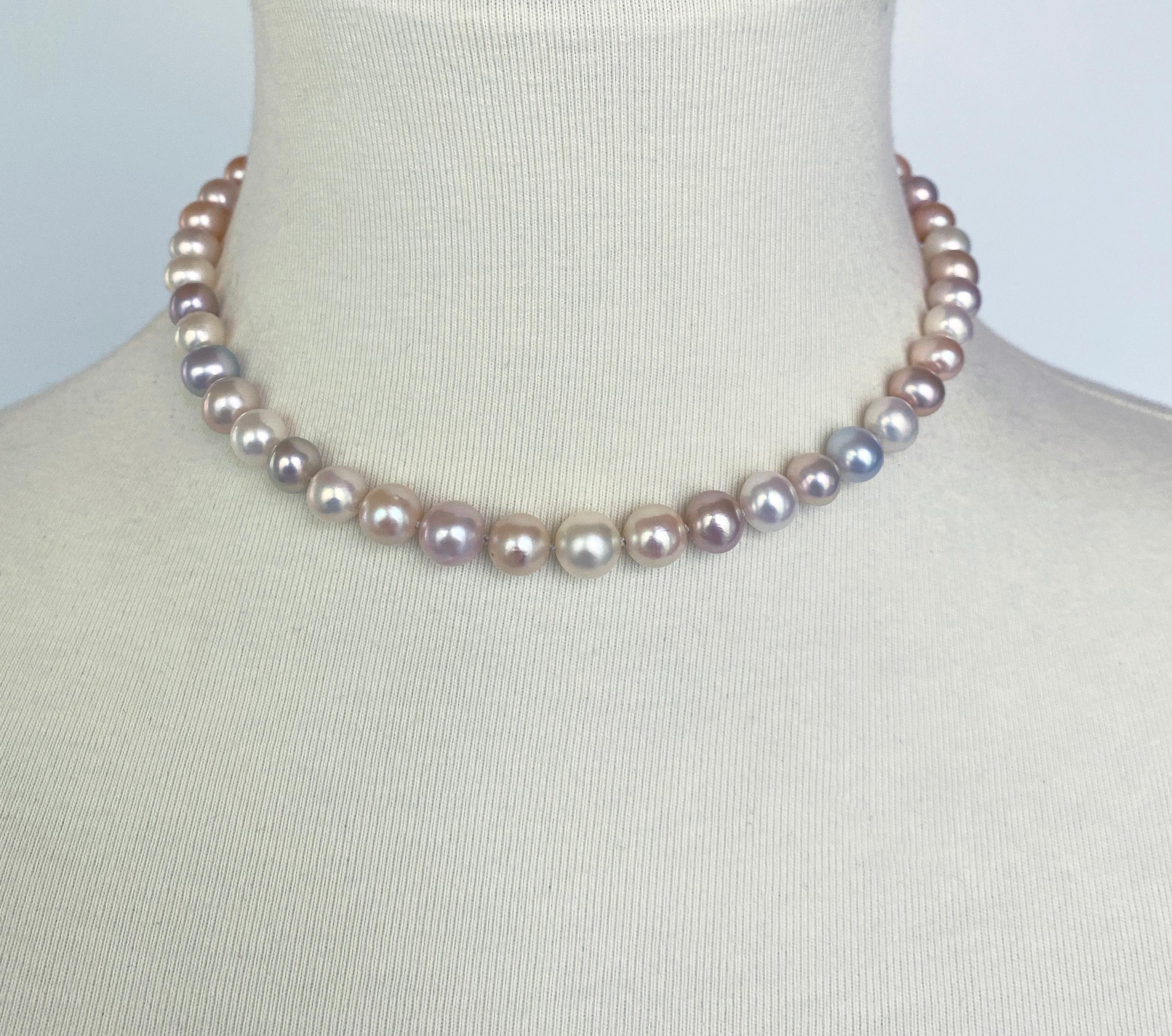 Some like it simple! Inspired by 1950s debutantes, This beautiful multi colored Pearl necklace features slightly graduated high luster Pearls displaying pink, blue, purple, green and yellow undertones. Double knotted, this necklace features a