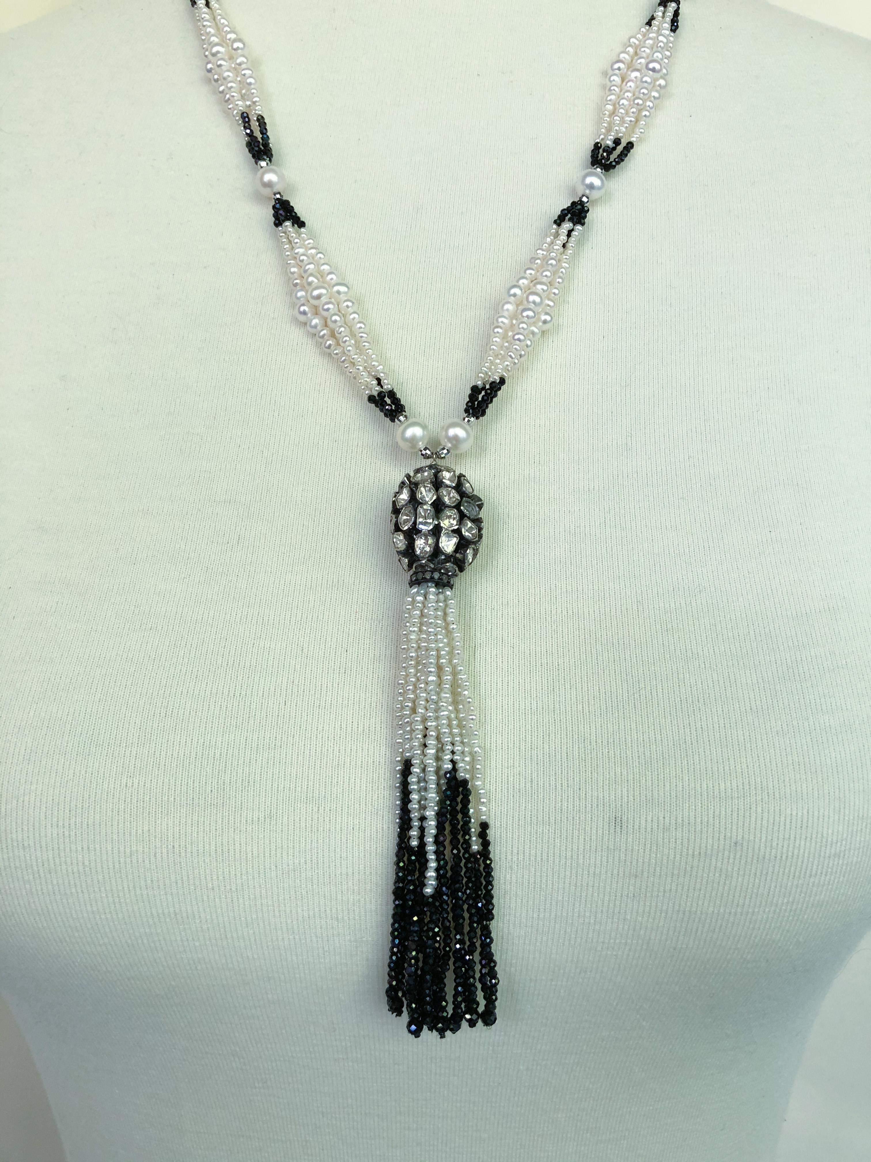 This stunning necklace is made up with multiple strands of double graduated white pearls (1-4 mm) strung between black spinel beads (1 mm), silver rhodium-plated beads (2.5 mm), and a larger white pearl (5-6 mm). The tassel features a large silver