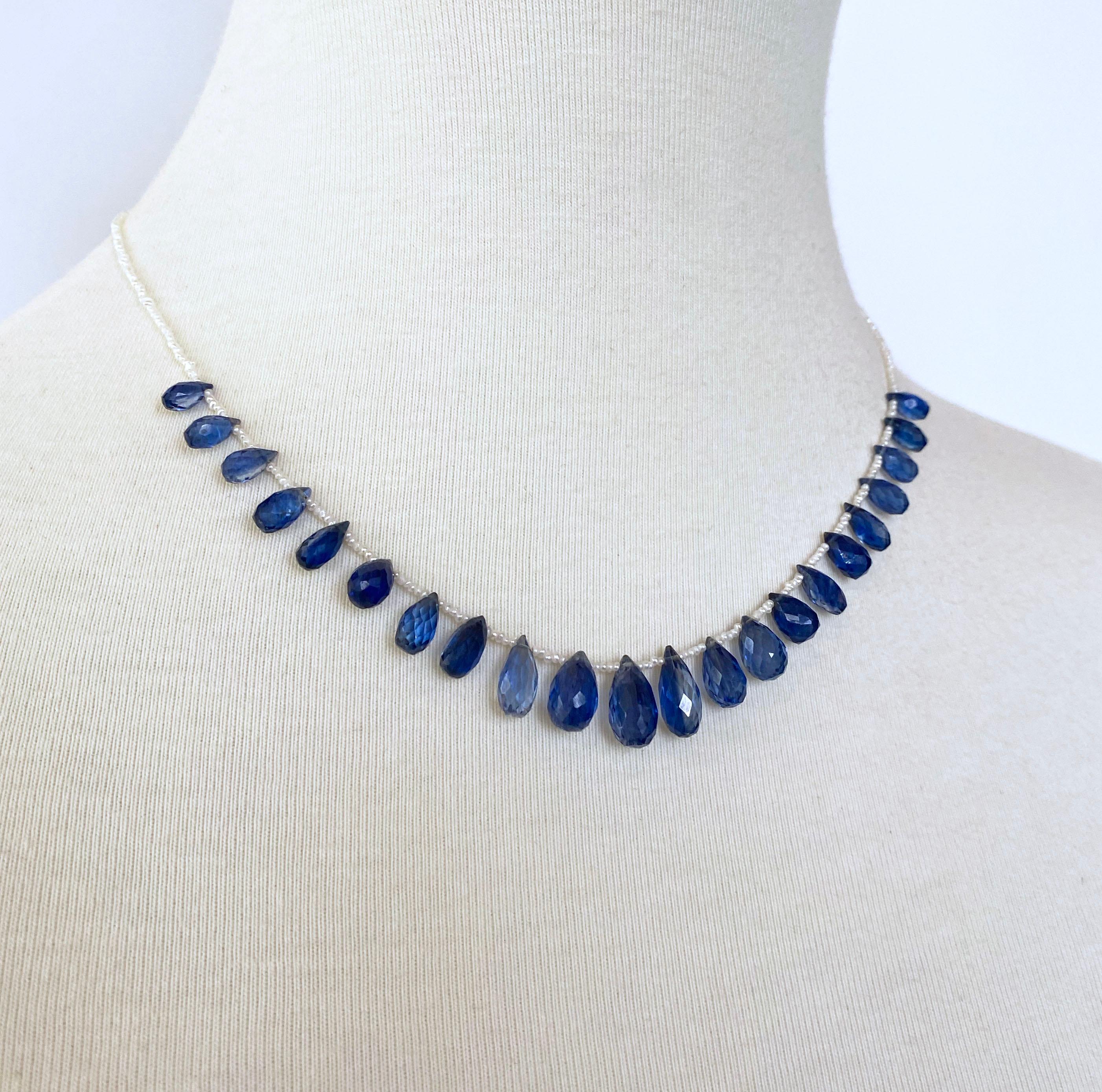 Simple yet classy necklace by Marina J. This piece features Natural Seed Pearls all beautifully adorned by multi faceted bright blue Kyanite Briolettes. These briolettes illuminate and radiate amazing hues of Blues when hit with light due to their