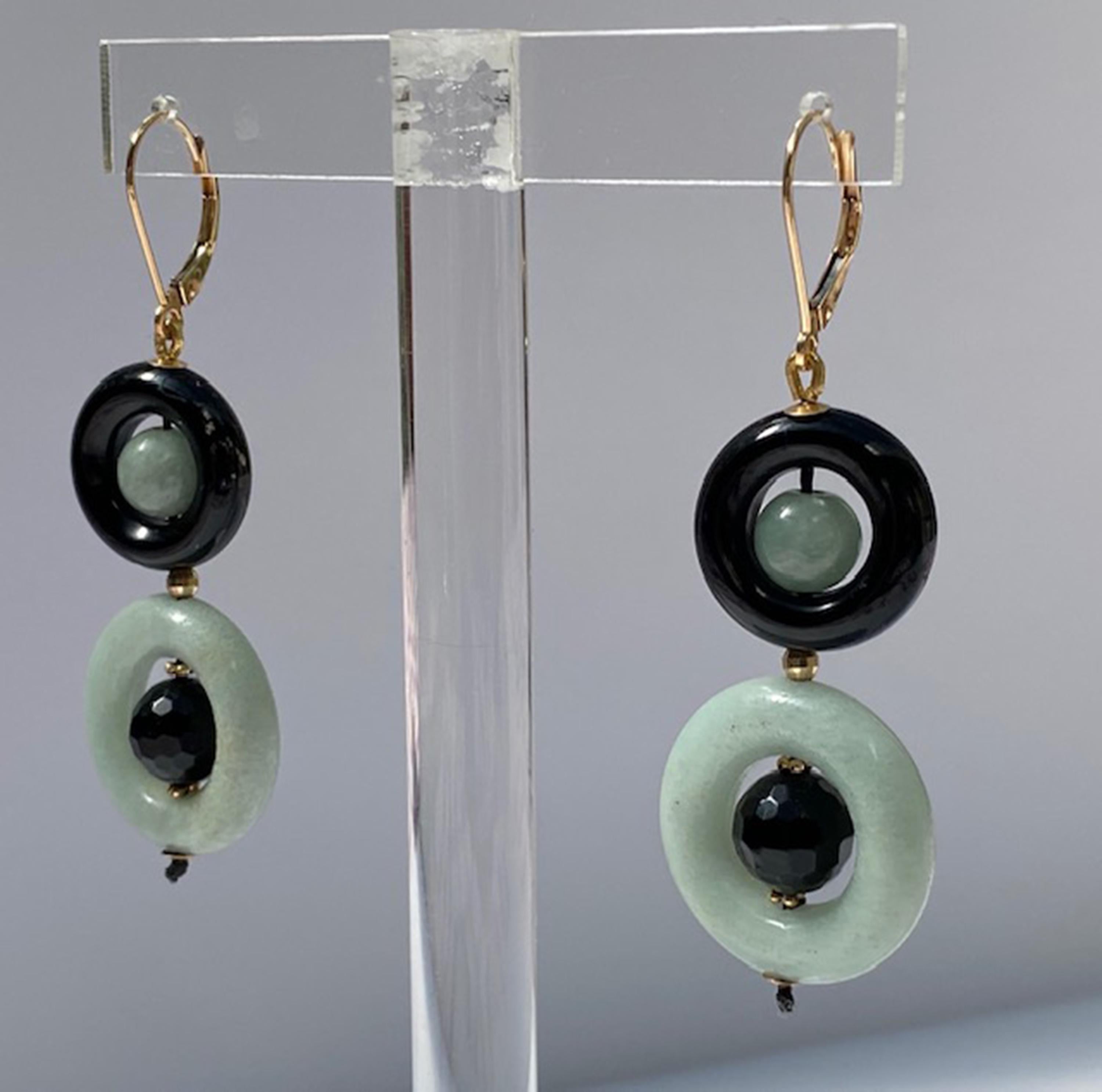 These elegant and sophisticated black onyx bead ring and jade bead ring earrings with 14 k yellow gold lever-back and wiring are beautiful and bold. The onyx rings contrast with the jade beads beautifully making, what could have been simple earrings