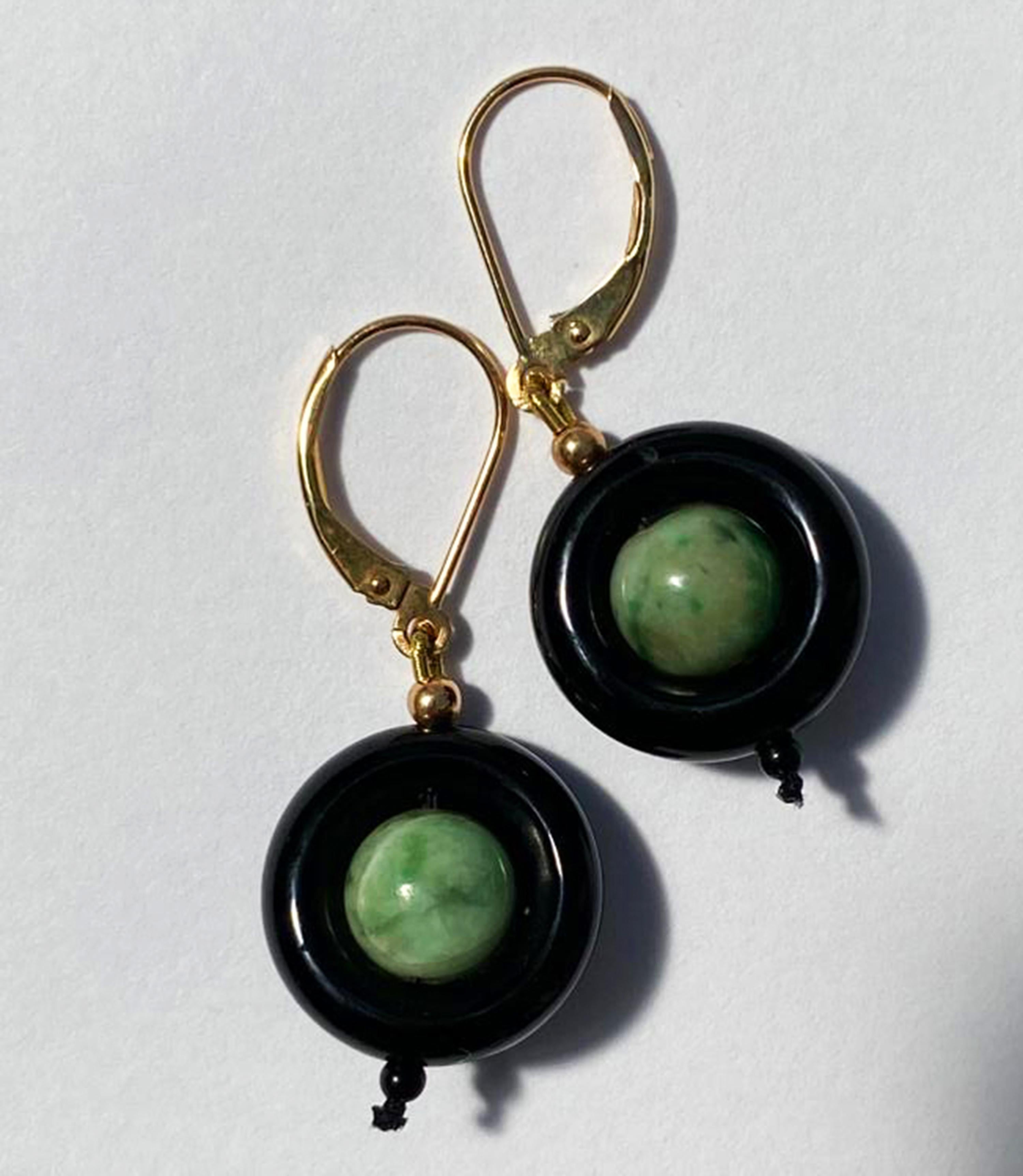 These unique black onyx ring and jade earrings with 14 k yellow gold lever-back and wiring are elegant and bold. The onyx rings contrast with the vibrant jade beautifully making, what could have been simple earrings dramatic and eye-catching. The 14