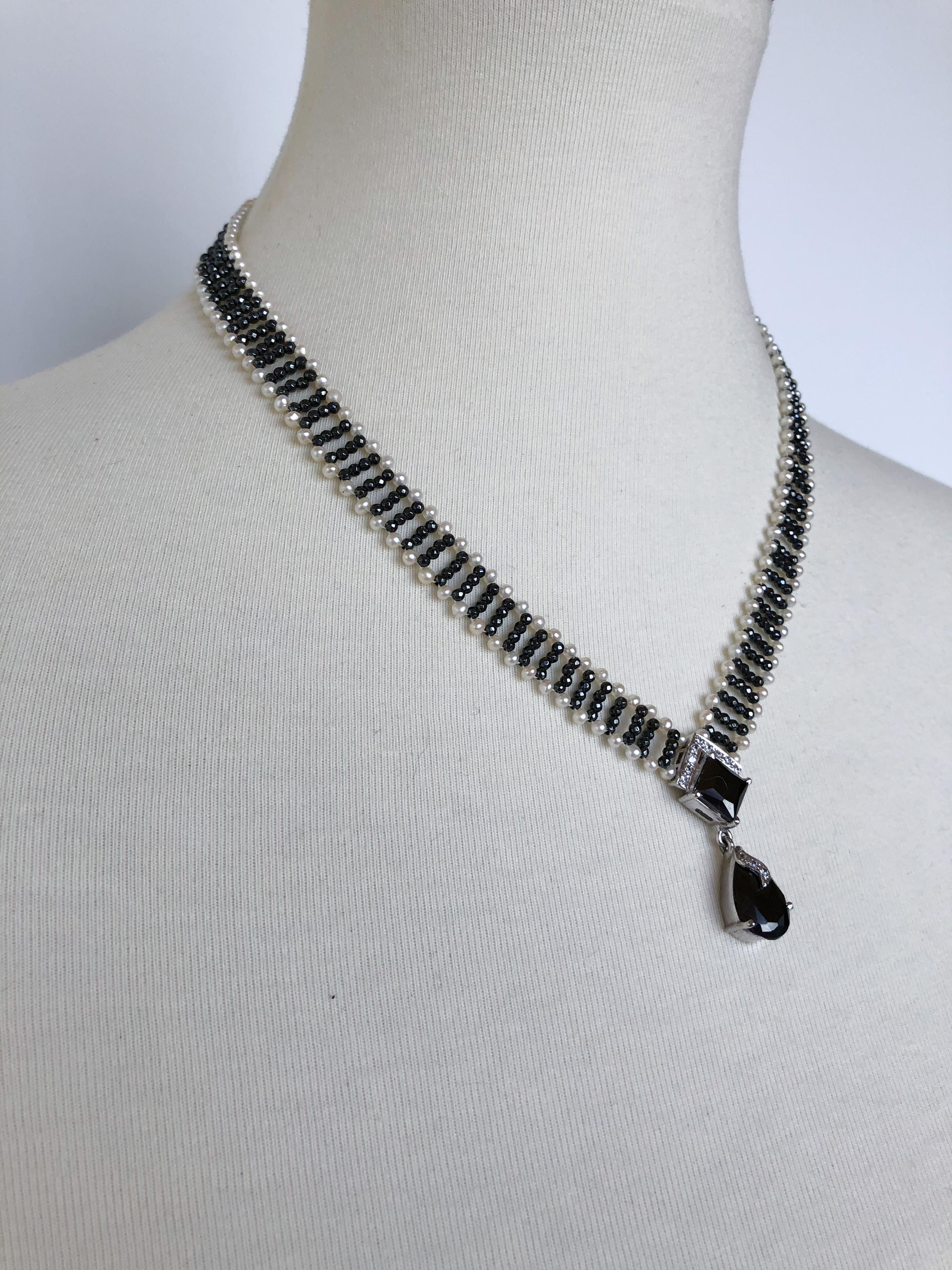 This stunning necklace is sure to take people's breath away this holiday season! The necklace is made with a ladder-like deign, consisting of small hematite beads and and small white pearls. The centerpiece is made with hematite and diamonds, on a