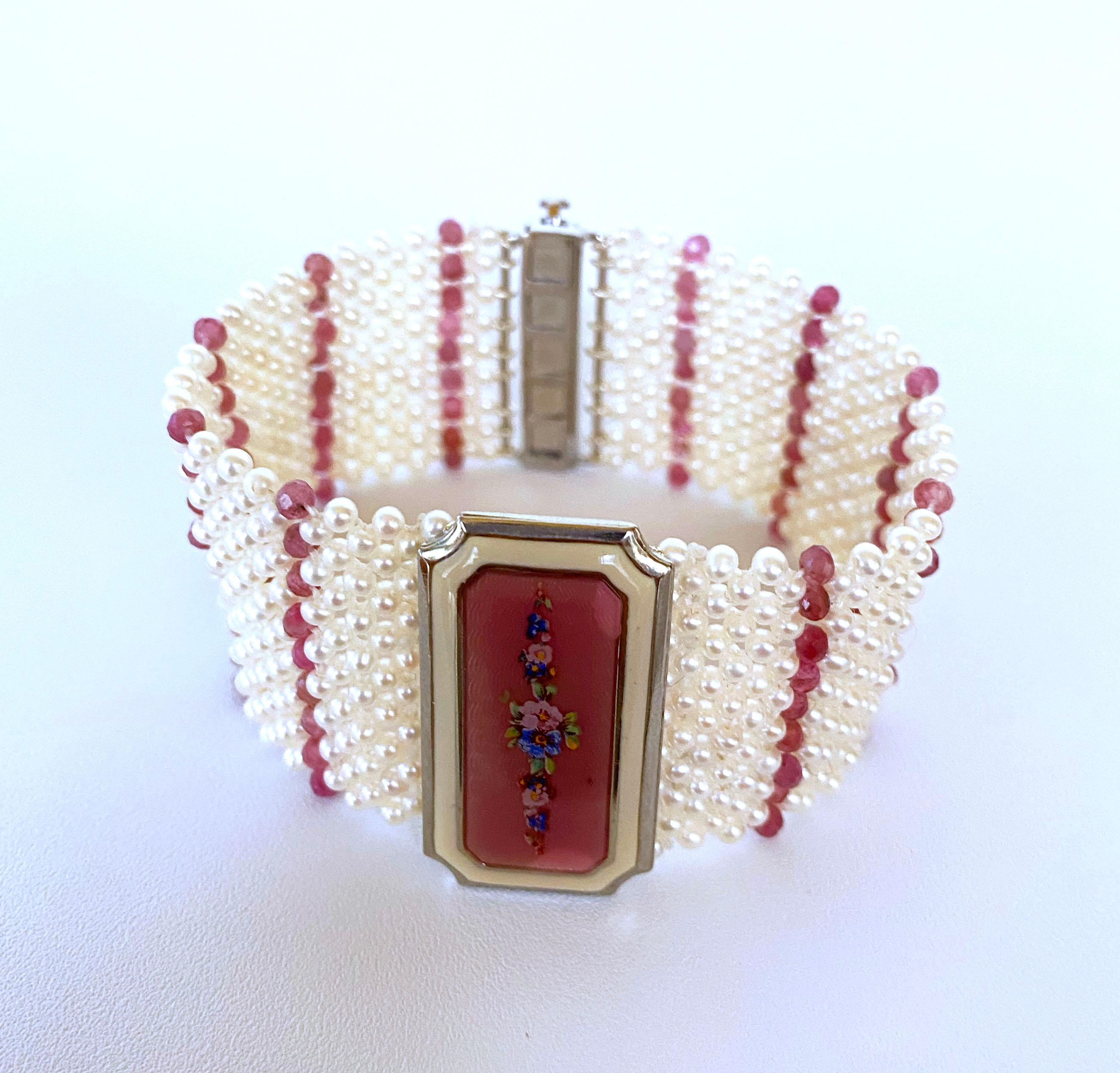 Handmade bracelet by Marina J. Bracelet features a vintage 1940s Enamel brooch with a floral design, reworked  into a magnificent centerpiece. This intricately woven bracelet is made with small high luster white/cream Pearls and beautiful baby Pink