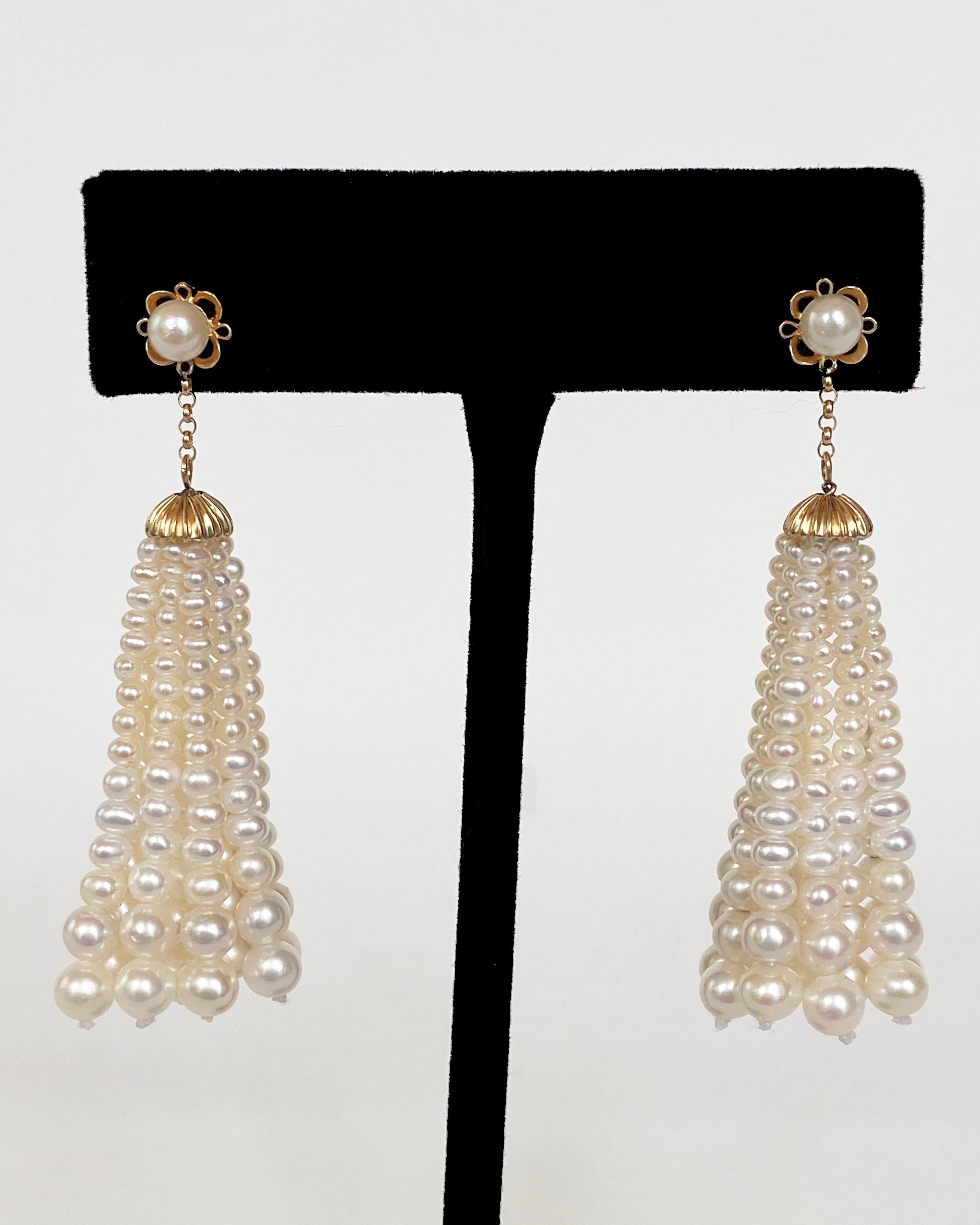 Light yet bold pair of Earrings by Marina J. This elegant pair features a Pearl embedded solid 14k Yellow Gold Flower, with a studded back. A short solid 14k Yellow Gold chain hangs underneath the Floral design, from which a solid 14k Yellow Gold