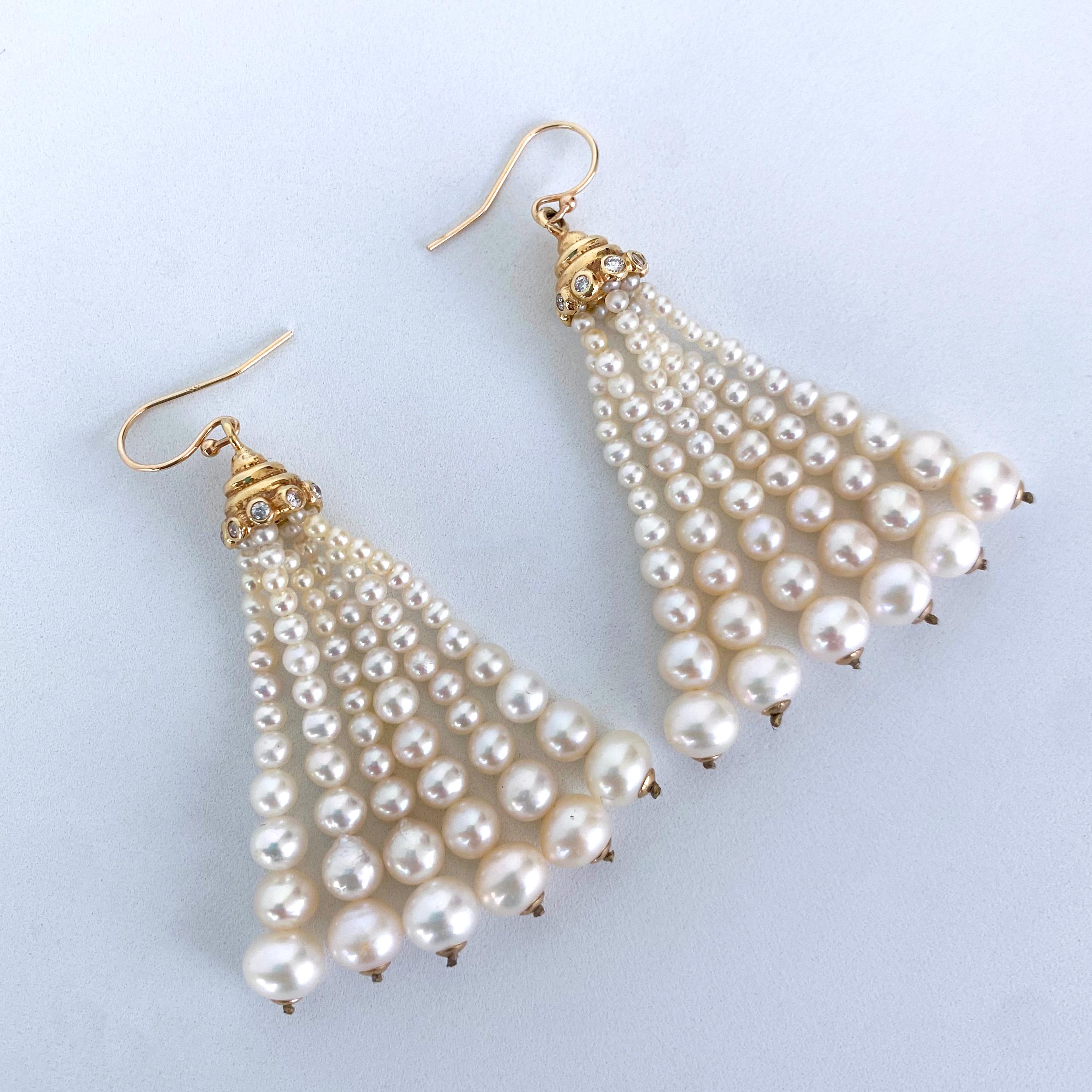 Beautiful pair of Earrings. This pair is made with all cultured Pearls, Solid 14k Yellow Gold & Diamonds. Two Solid 14k Yellow Gold Cups with encrusted Cushion Cut Diamonds hang off Solid 14k Yellow Gold hooks, from which multiple strands of