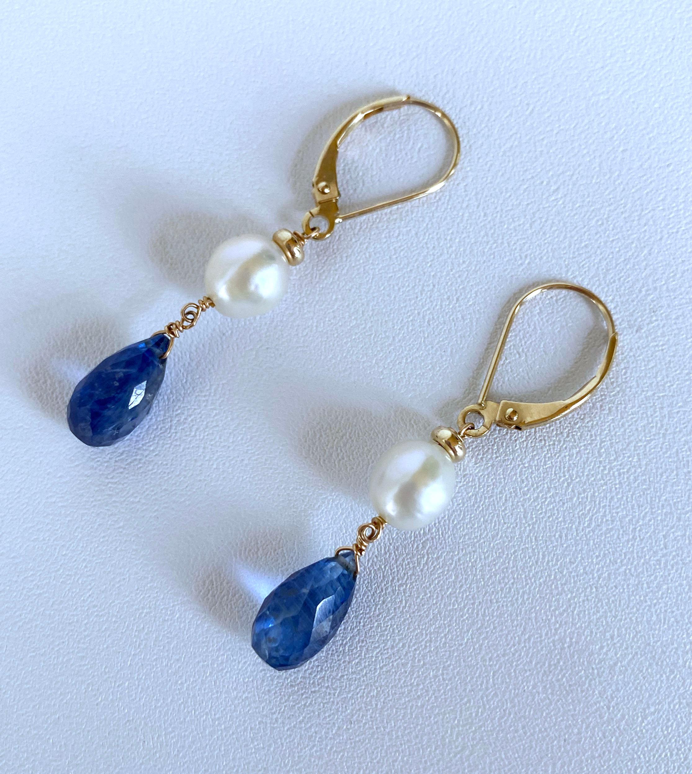 Gorgeous pair of earrings handmade by Marina J in Los Angeles. This lovely pair is made with all 14k Yellow Gold wiring and Lever Back Hooks. The pair features stunning faceted Blue Kyanite Briolettes hanging from Baroque high luster White Cream