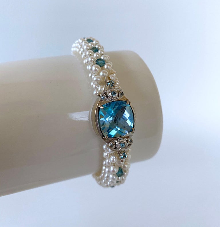Beautiful hand woven bracelet by Marina J. This gorgeous piece is made using 2mm - 2.5mm Pearls, intricately hand woven into a 3 dimensional lace like design. As shown in photos, this bracelet has a dome like curve, while the underside of this