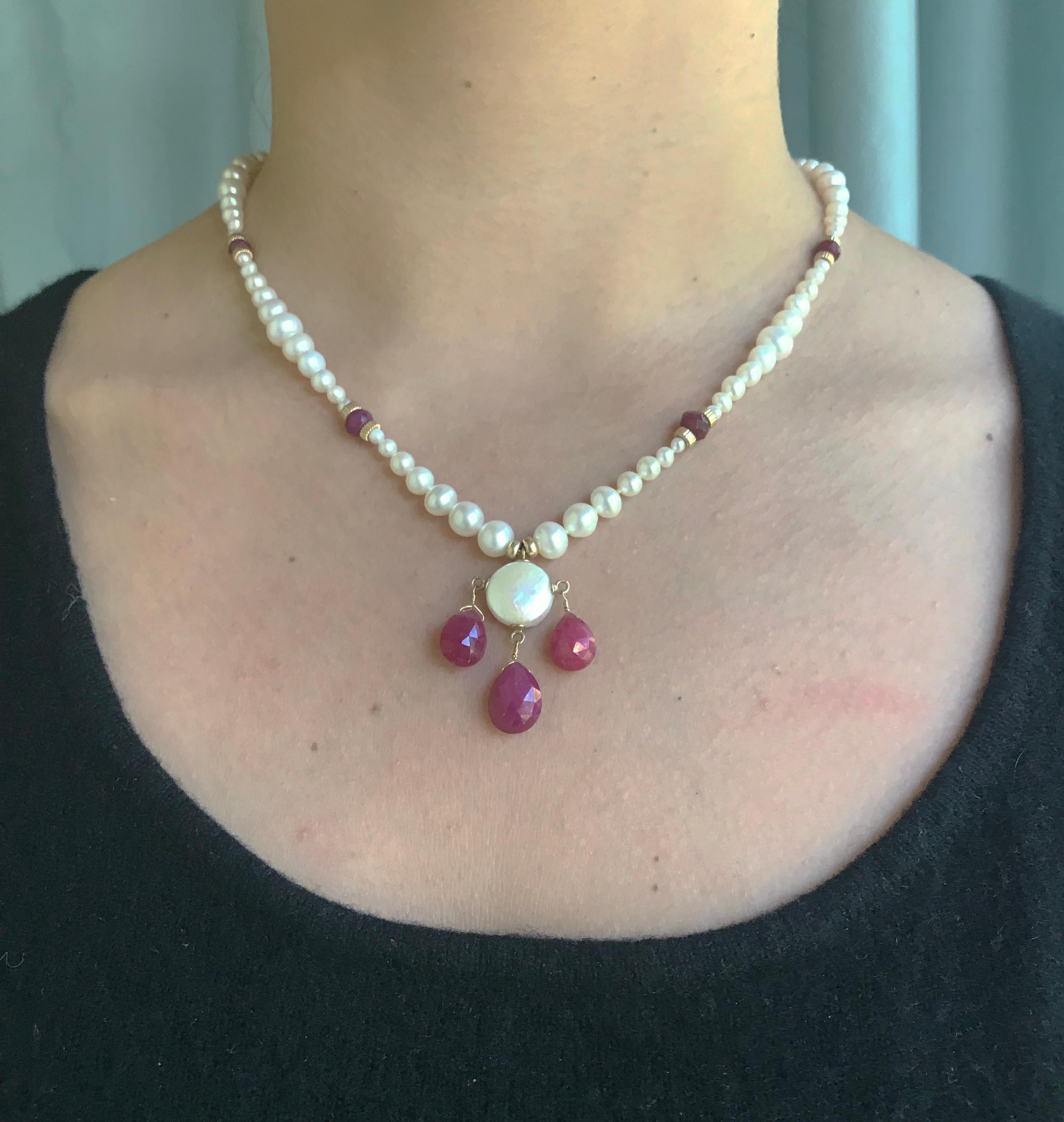 This romantic pearl necklace has a delicate pearl coin with teardrop ruby beads and 14k yellow gold beads and clasp. The white pearl necklace is 18.5 inches in length, highlighting the grace and elegance of the neckline. Each pearl was carefully