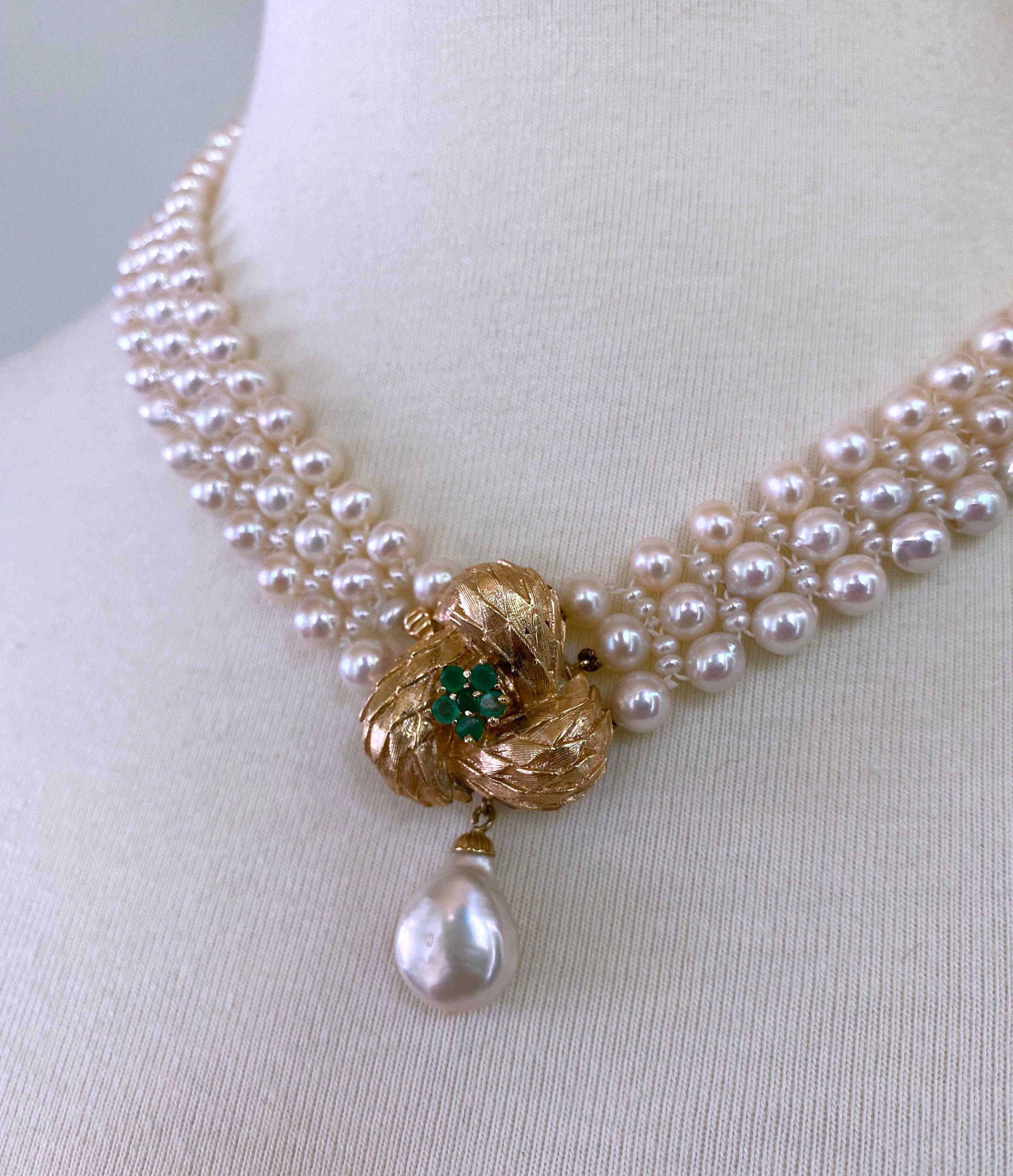 This handwoven white pearl necklace with emerald and 14 k yellow gold floral centerpiece is beautiful and practical as the centerpiece acts as a front-facing clasp. The centerpiece is made of 14 k yellow gold with a central green flower emerald and