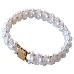 Marina J. Bracciale con perle intrecciate e chiusura in oro giallo massiccio 14k