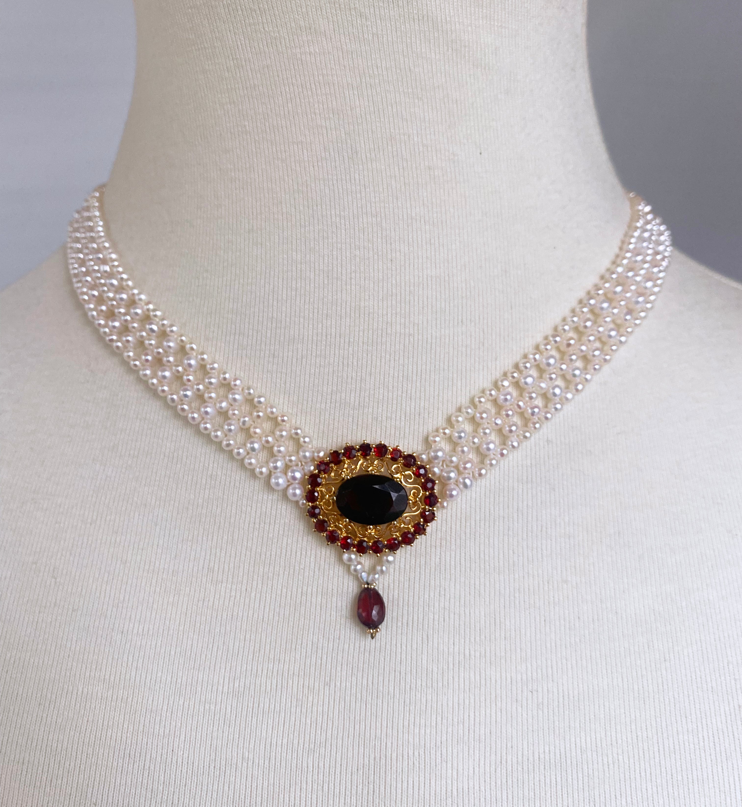 Beautiful 'V' necklace by Marina J. This piece has reworked a vintage Garnet brooch into a wonderful necklace Centerpiece. The brooch features a large Garnet stone bordered by brilliantly pigmented Cushion cut Garnets, all set on a Gold Plated