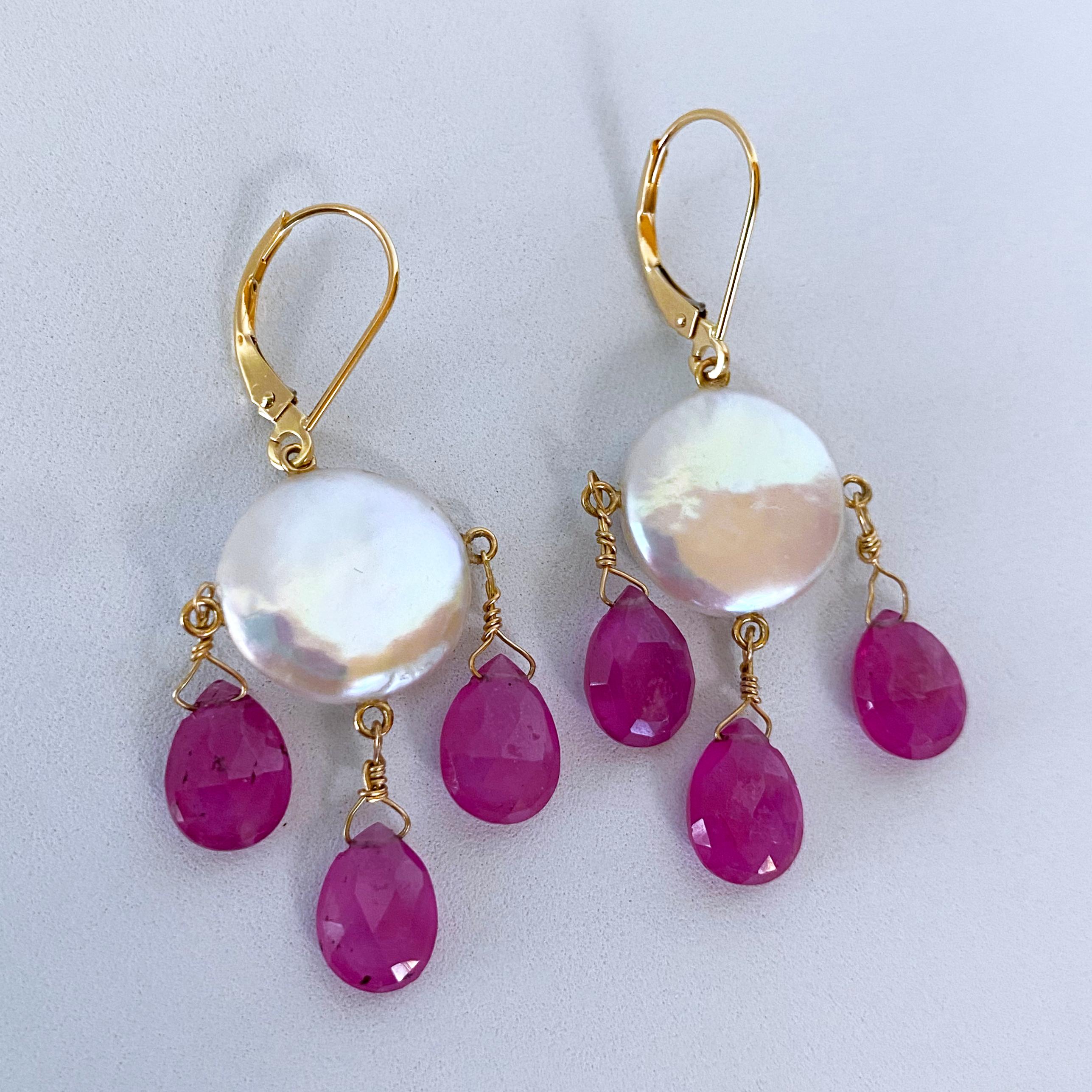 Stunning pair of Earrings by Marina J. This pair is made with all solid 14k Yellow Gold wiring and hooks. A Coin Pearl with a beautiful iridescent luster sits as three vivid Pink Ruby teardrop Briolettes hang from it. The Pink Rubies displays a