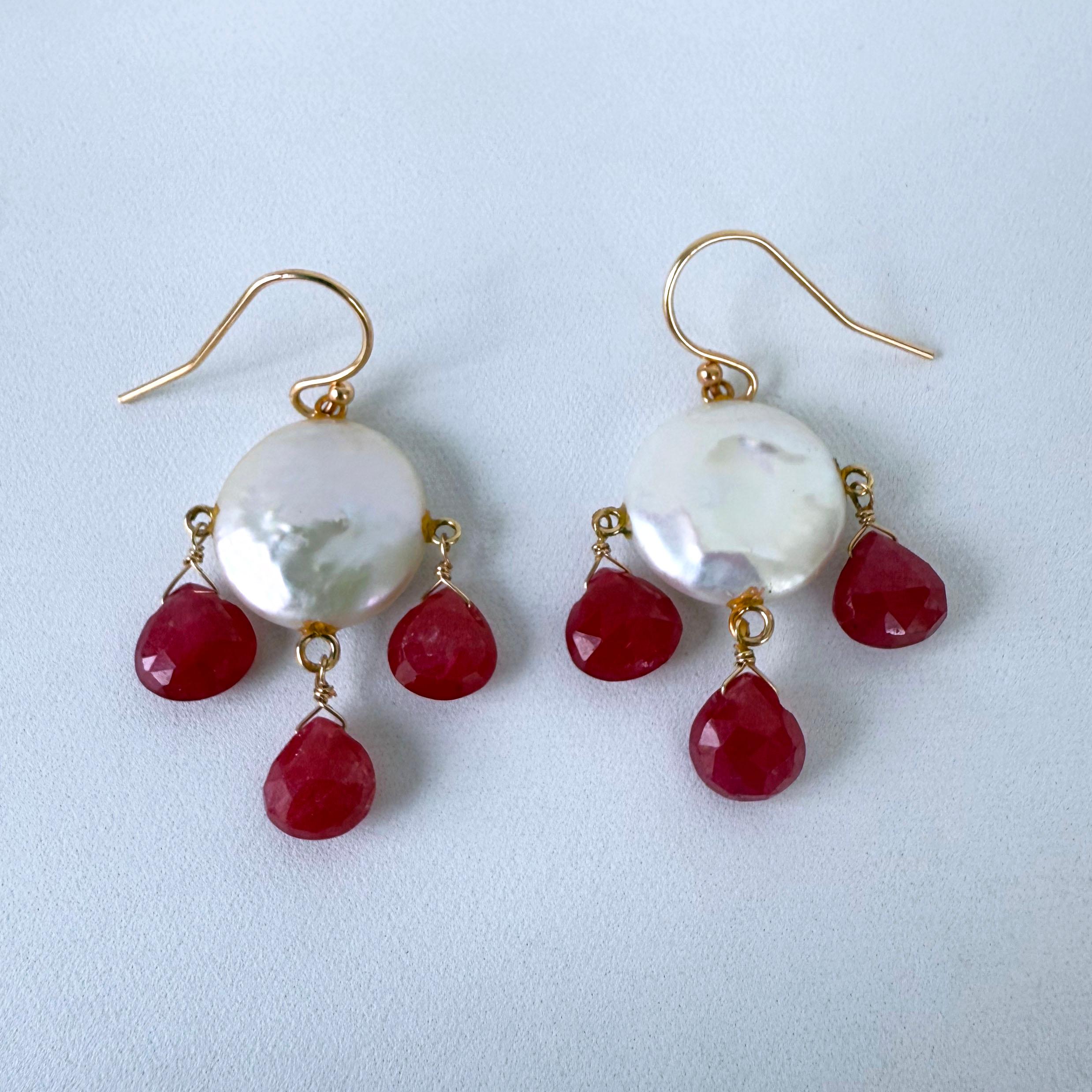  Ruby Chandelier Earrings by Marina J.
This pair features two Baroque Coin Pearls displaying vivid iridescent luster and texture, hanging off Solid 14k Yellow Gold hooks. Three faceted teardrop Fuchsia Rubies hang from each Pearl, creating a