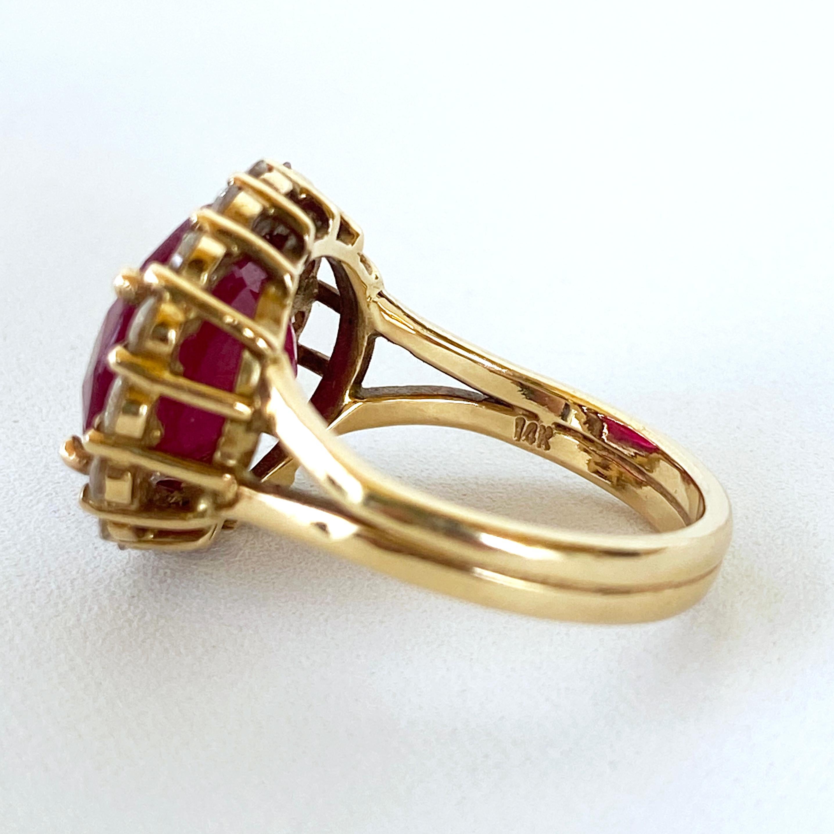 Brilliant ring by Marina J. This stunning piece features a large faceted Ruby, displaying a vivid Red / Deep Fuchsia tone. Due to its semi translucent nature, the Ruby radiates magnificent color when hit with light. Set in solid 14k Yellow Gold, The