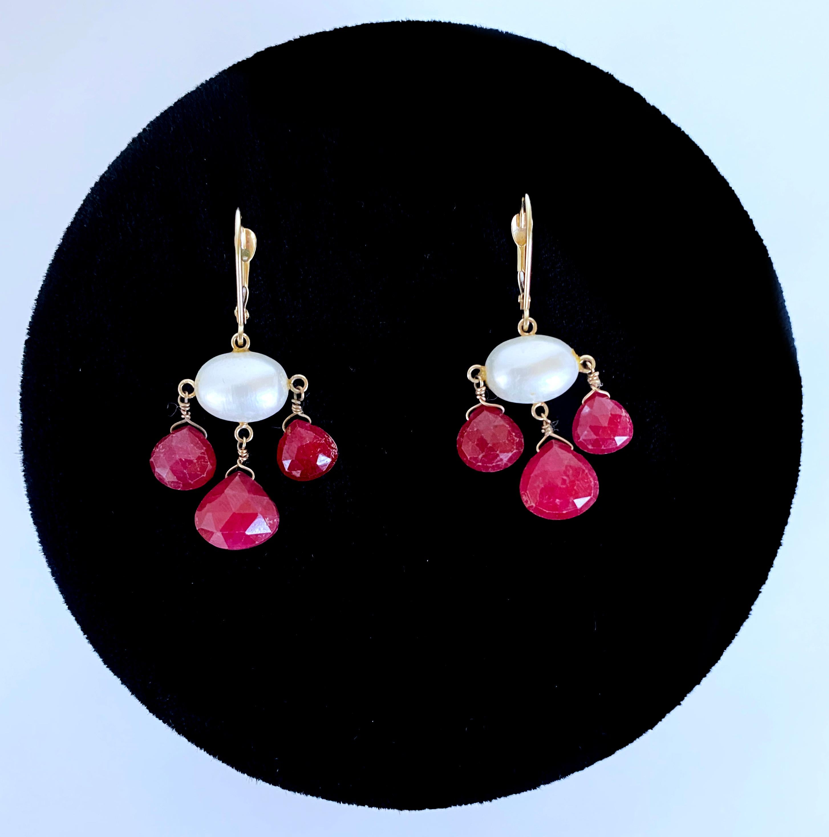 Simple and bold pair by Marina J. Each earring features 3 Graduated and faceted Pear shaped Rubies that display a vivid and radiant Hot Pink / Red Color. The three magnificent Rubies in each pair hang off a high luster Baroque Pearl which glistens