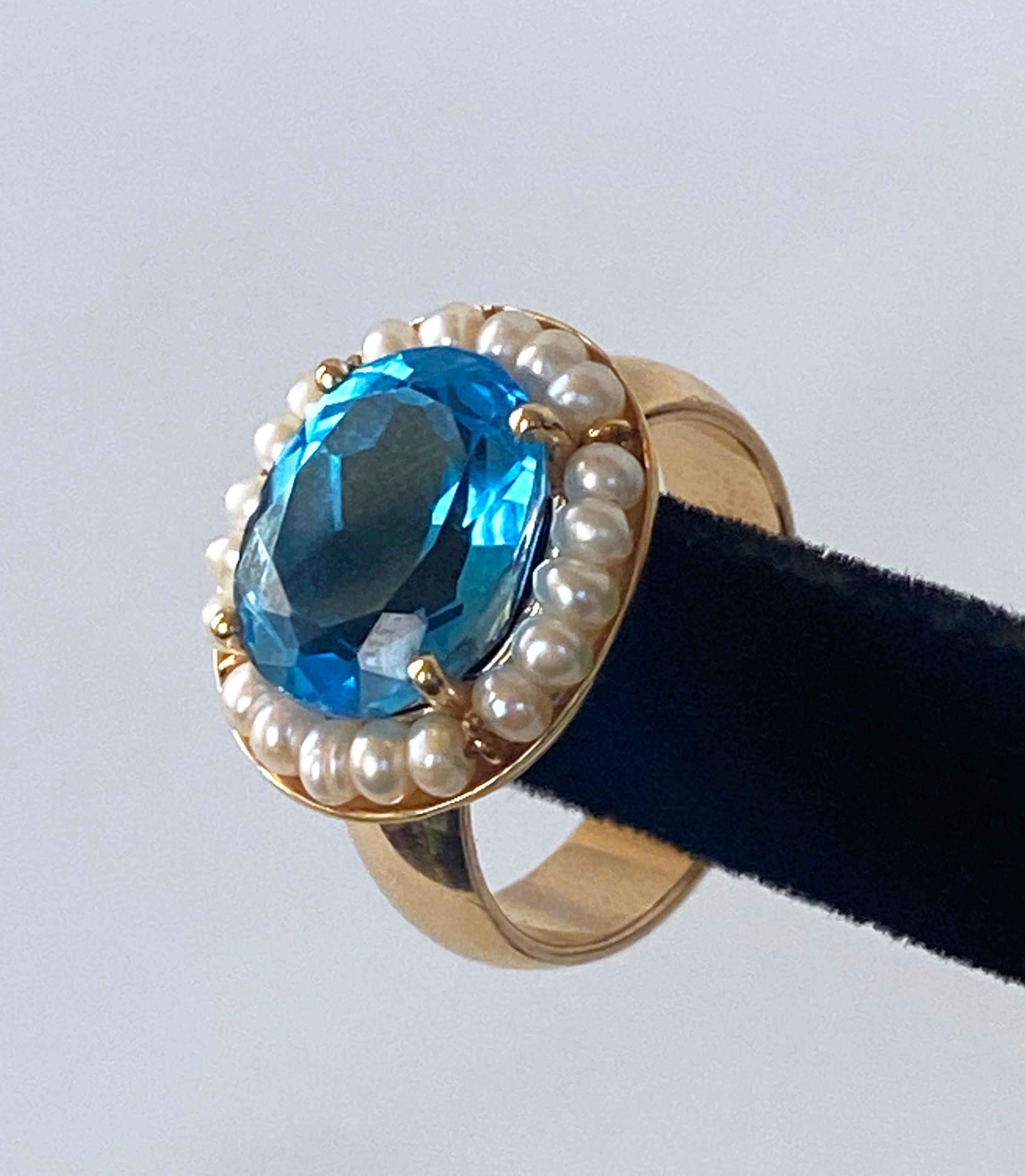 Gorgeous and color size 6 ring made by Marina J. This amazing piece features a 6.55 carat London Blue Topaz gemstone, with a magnificent cut that allows the Topaz to flash radiant hues of Sky Blue when hit with light. Surrounding the Topaz are 20
