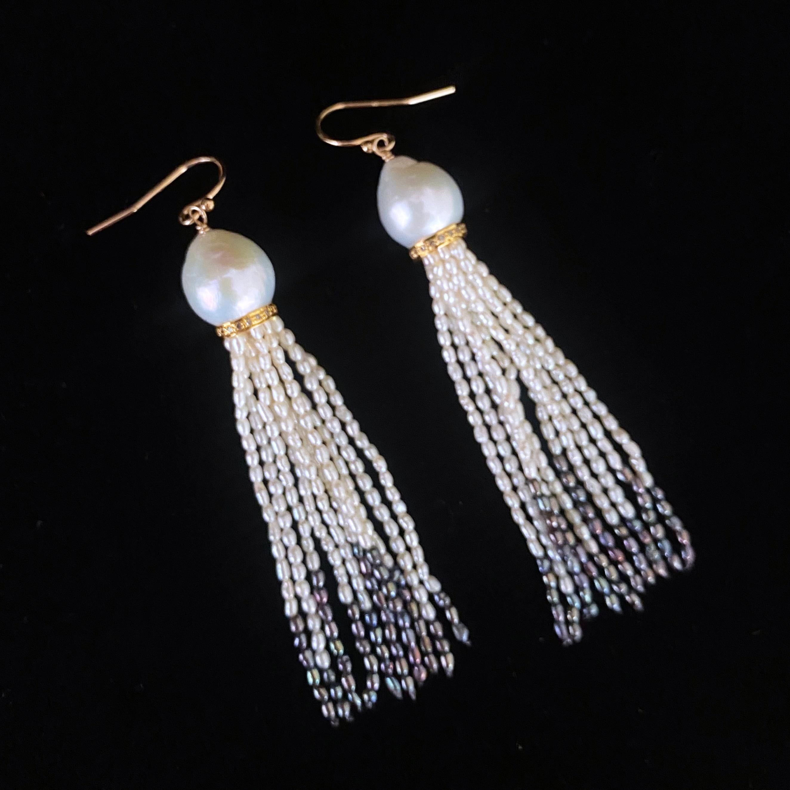 Beautiful pair of Earrings by Marina J.

This pair is made with all Pearls and solid 14k Yellow Gold. Two iridescent teardrop shaped Pearls sit atop a 14k Yellow Gold Plated - Diamond encrusted roundels, from which multiple strands of Seed Pearls