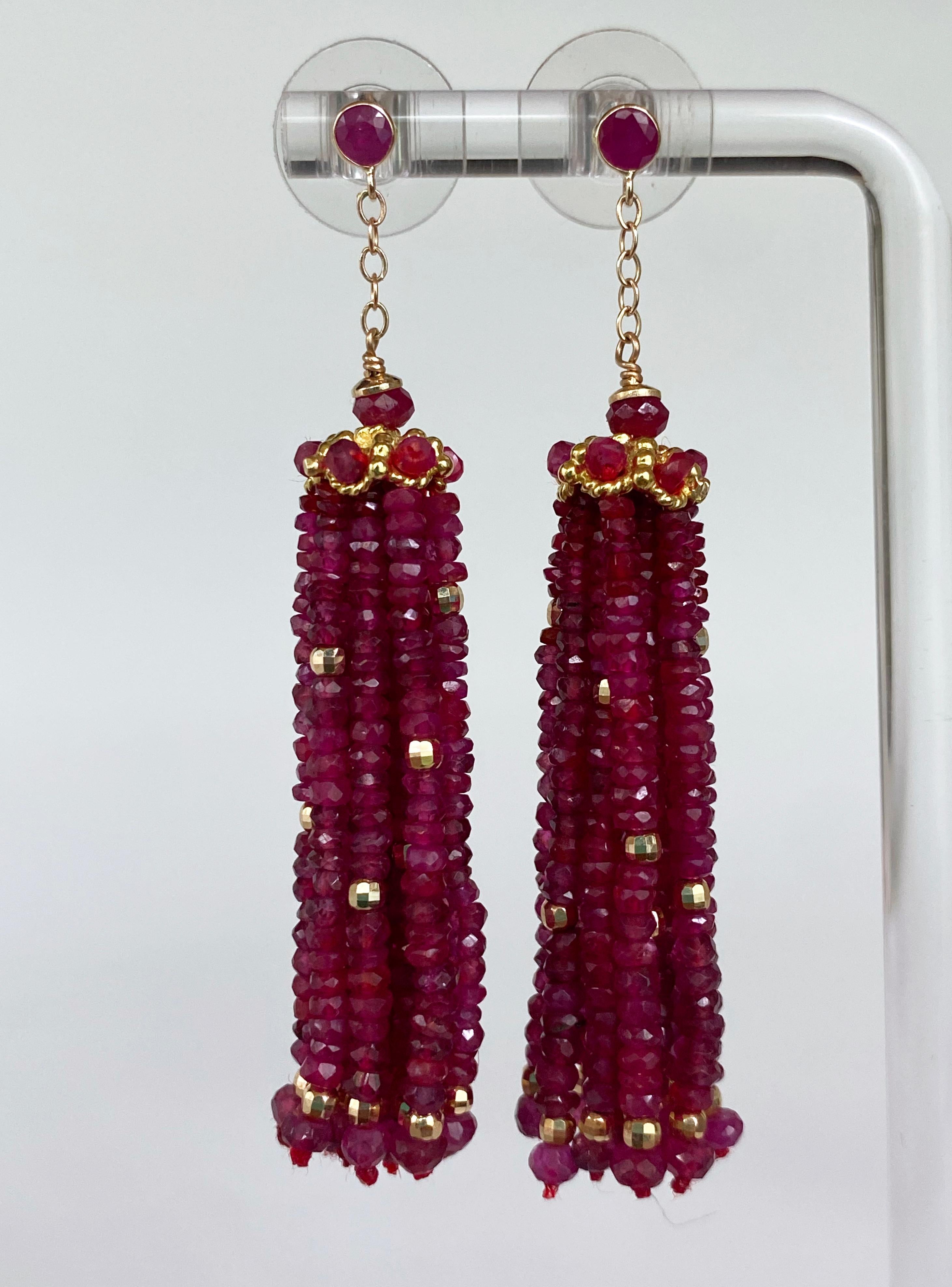 Stunning pair by Marina J. This striking set of earrings is made up of entirely solid 14k Yellow Gold and Faceted Rubies. A small Ruby sits atop a solid 14k Yellow Gold decorative Cup, which is adorned by Faceted Rubies encrusted within. From this