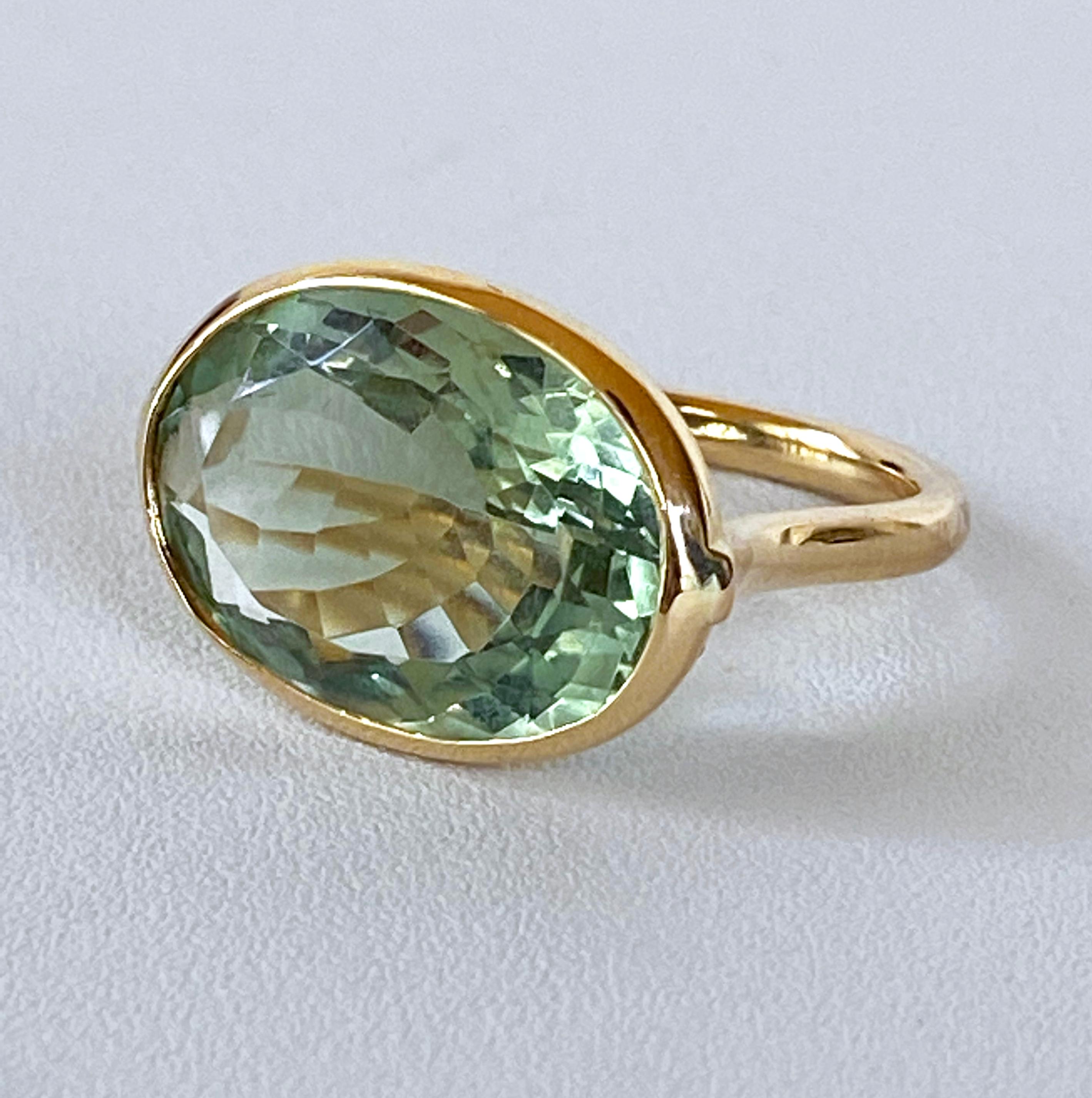 Gorgeous ring featuring a faceted oval 9.93c Green Amethyst stone - bezel set in 4.5 grams of solid 14k Yellow Gold. Ring interior is stamped 14k and is sized at 6.75 women's. Beautiful piece that flashes soft hues of Greens due to its perfect
