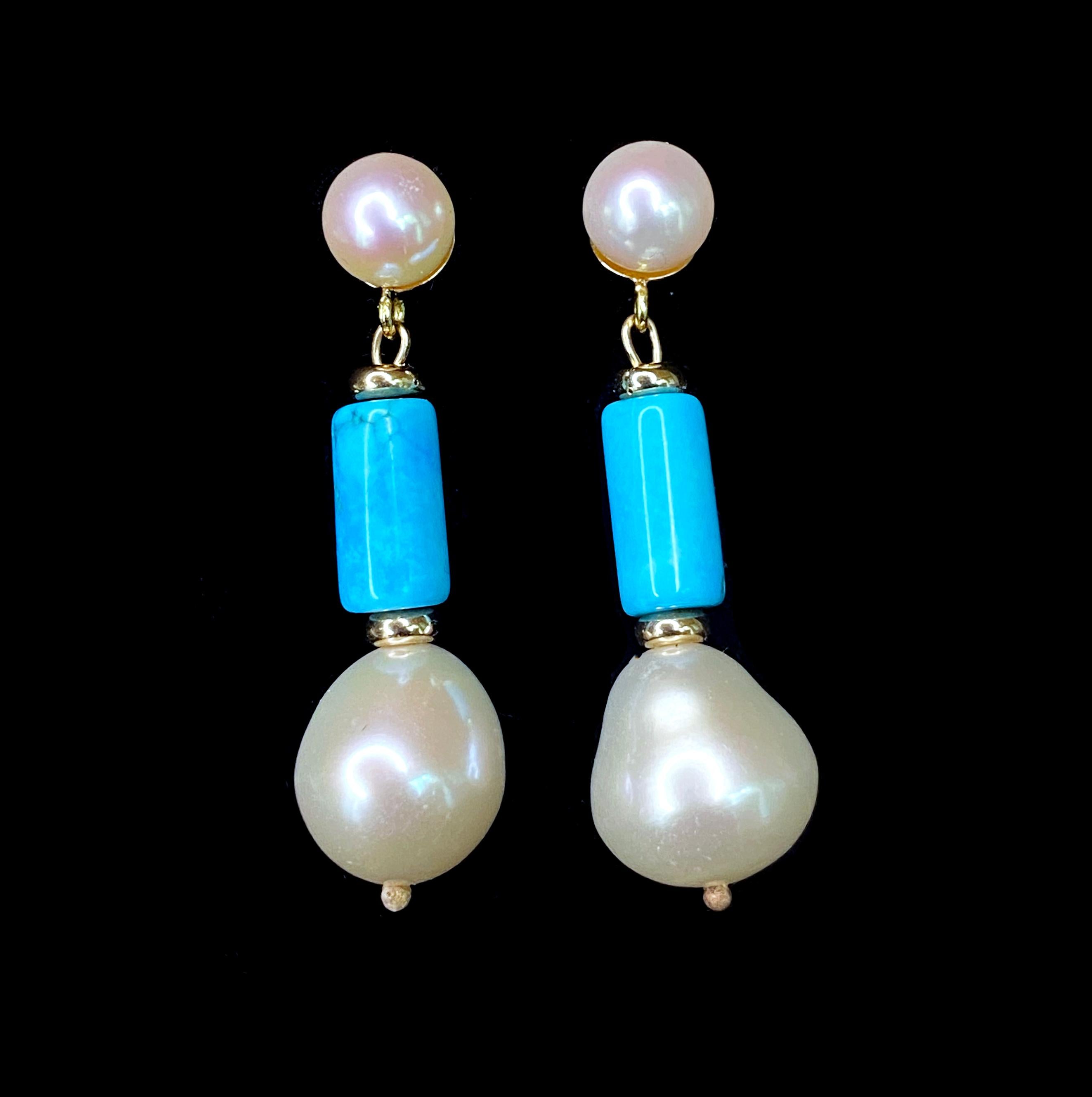 Bold yet simple pair of Earrings by Marina J. This lovely piece features a Pearl set Stud, from which a Turquoise Cylindrical Bead and Baroque Pearl Hang. Measuring 1.25 inches long each, this pair is made entirely of solid 14k Yellow Gold metal and