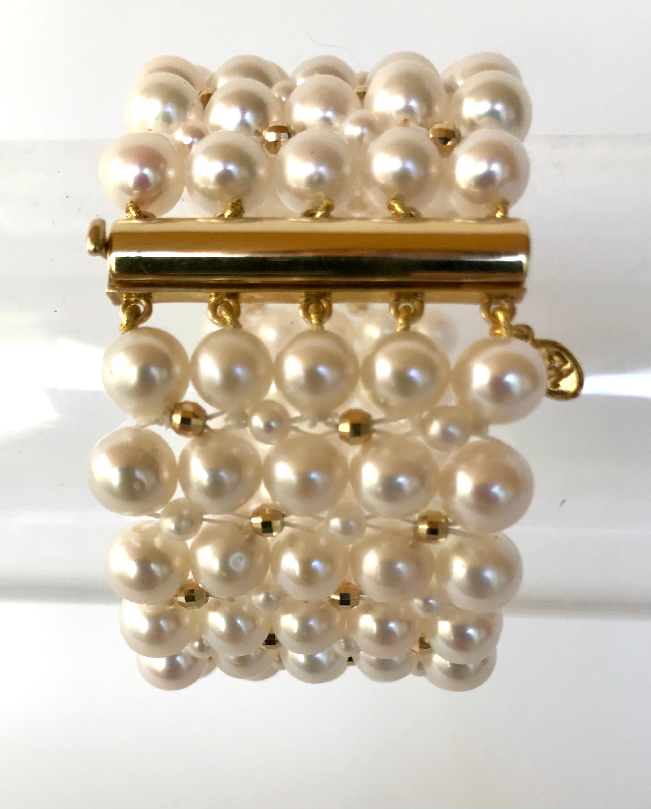 This timeless bracelet has an elegant pearl weave. At 1.5  inches wide the different size pearls create a checkered design with the 14 k yellow gold  faceted beads.
The bracelet is 7 inches and fits comfortably on the wrist like a band. The sliding