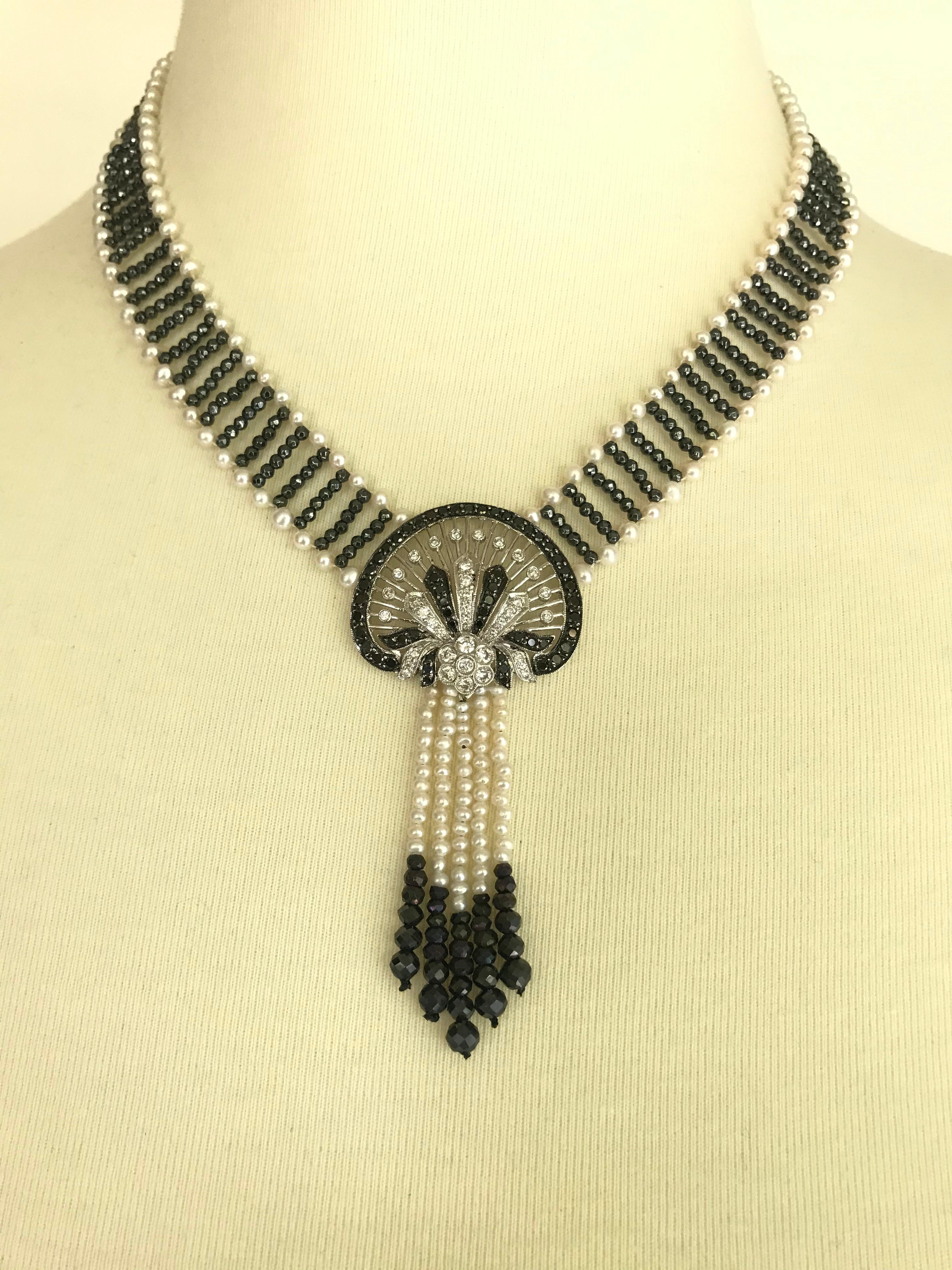 This is a vibrant ,one of a kind necklace with diamonds, black diamonds, pearls and hematite beads creating a lace like appearance. The magnificent hand woven piece is  accentuated with a  14 karat white gold centerpiece with dangling pearl and
