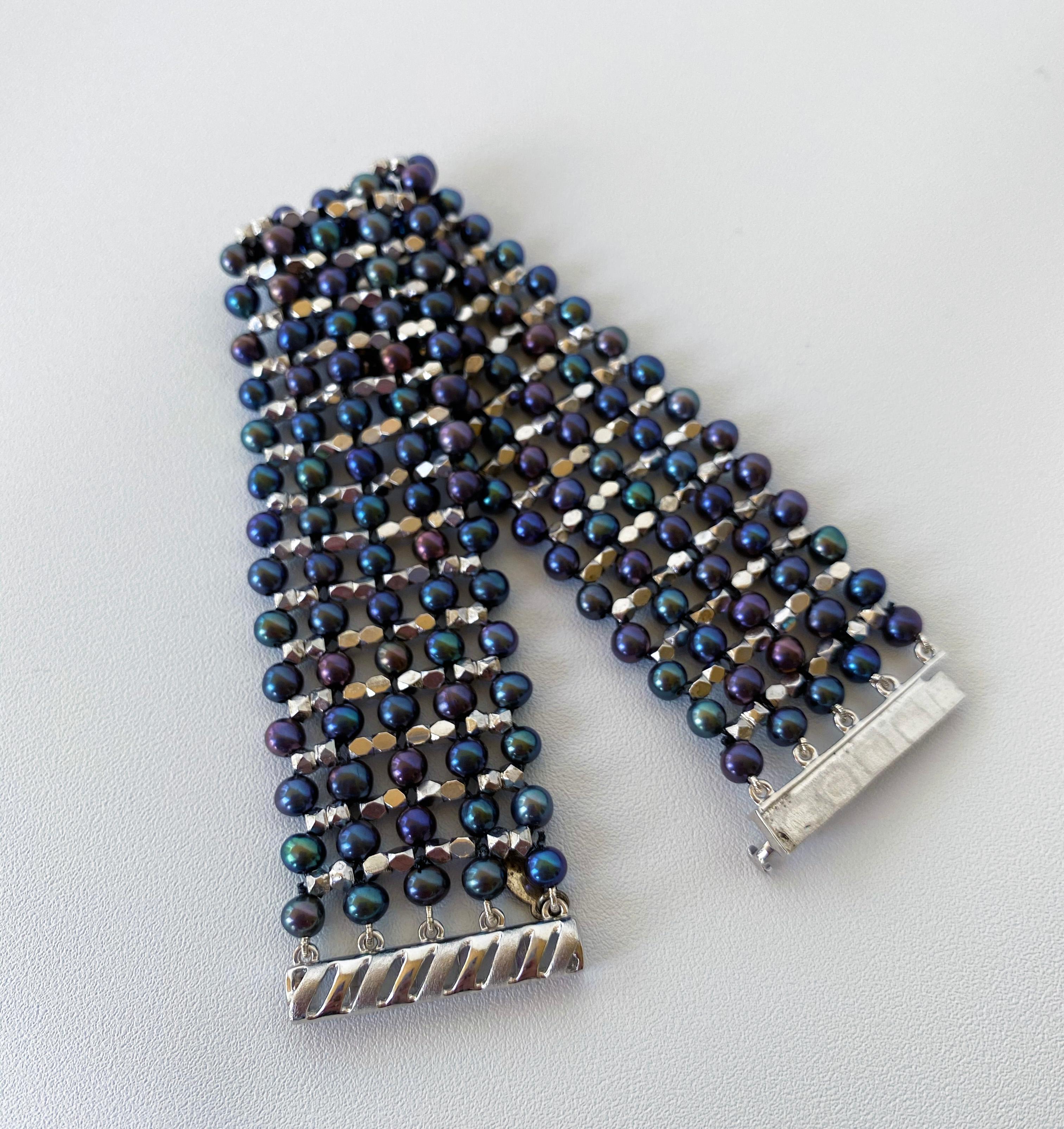 This black pearl, rhodium-plated, sterling silver, beaded, cuff bracelet is intricately handwoven by Marina J. Woven through the black pearls are rhodium plated sterling silver beads giving the bracelet dimension. The rhodium plating maintains the