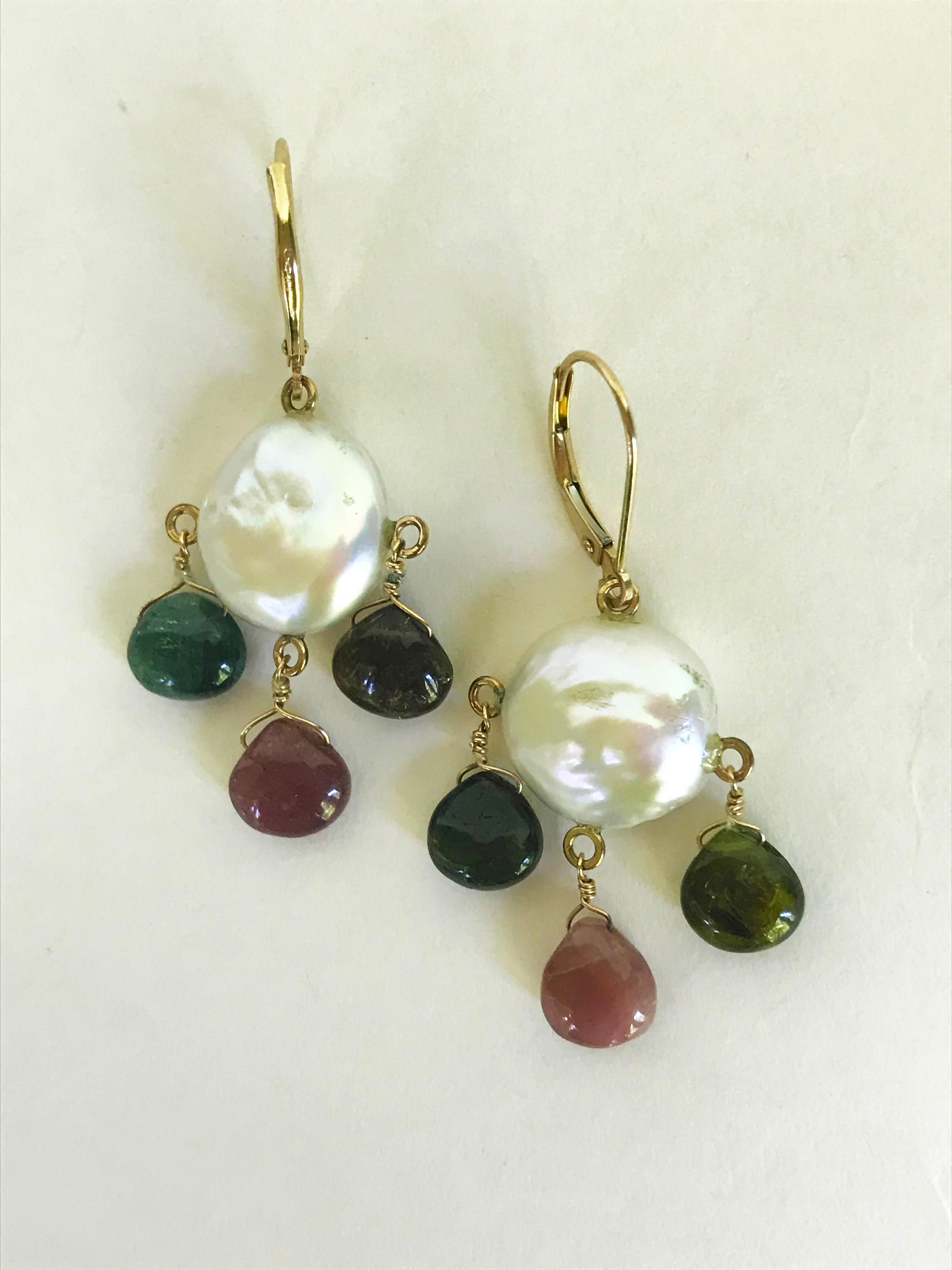 These beautiful earrings are made from 14k yellow gold wiring and Lever-back. The multi-color tourmalines drop from a flat coin-shaped white pearl. Inspired by an Autumn-themed color palette, these elegant yet whimsical earrings are intentionally
