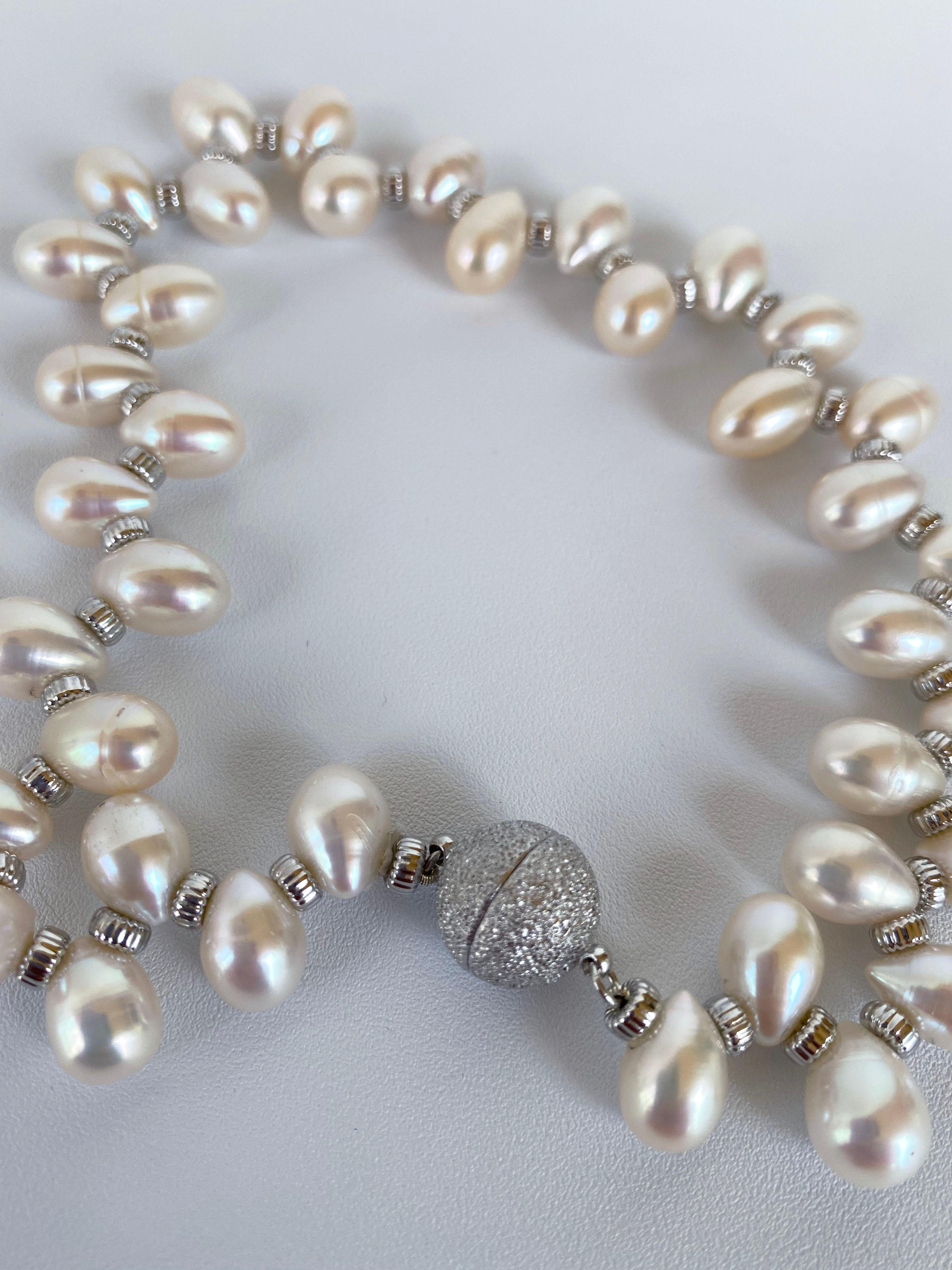 Perfect piece for your furry best friend. This necklace features Real White Teardrop Pearls separated by Silver Rhodium Plated Roundales. This elegant and formal necklace is a wonderful addition to make your pet spark! This necklace meets as a