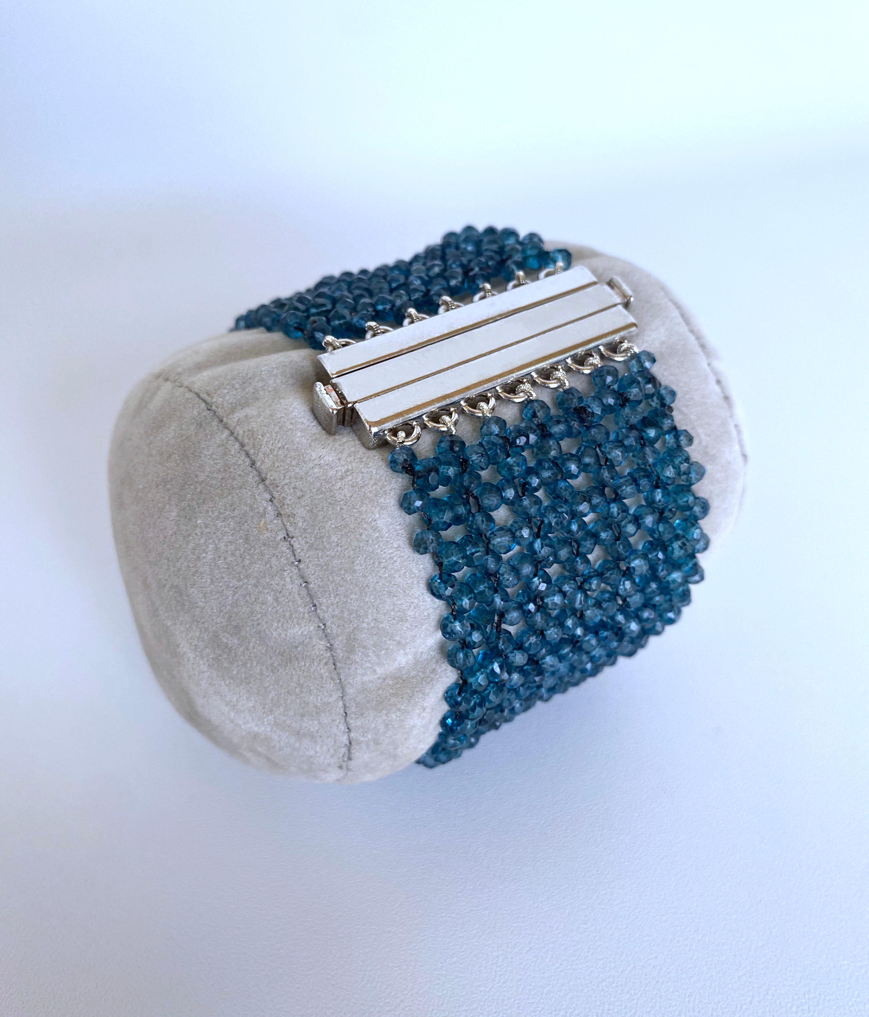 The deep blue topaz beads are woven together into a 1.25-inch wide bracelet. The shimmer of topaz beads is highlighted by the silver press clasp. This rhodium-plated silver clasp is also very secure and easy to use clasp. The clean lines of the