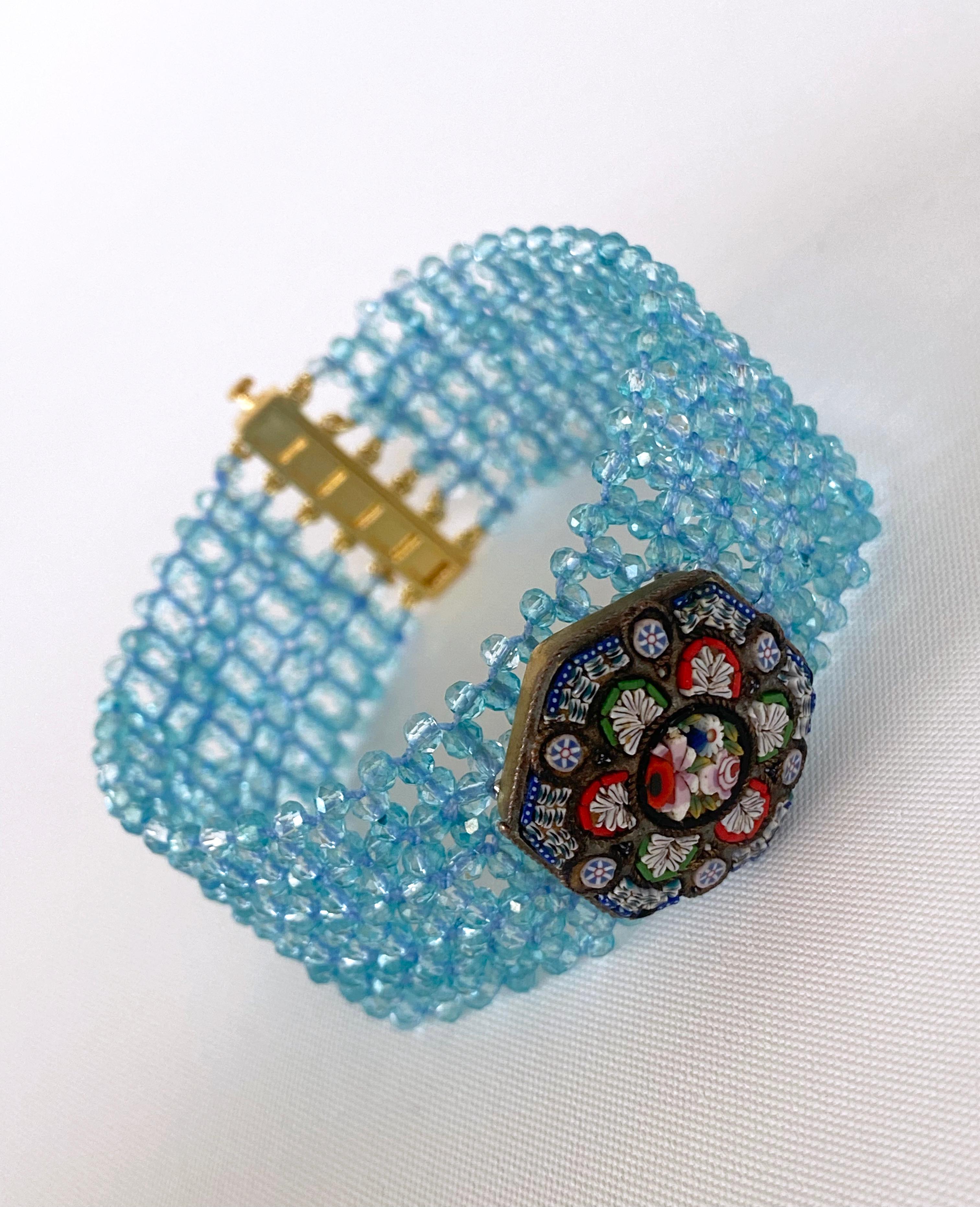 Gorgeous piece hand made by Marina J. This bracelet features brilliantly pigmented bright Aquamarine faceted beads, all intricately woven together into a fine lace like design. The beads translucency allow them to radiate magnificent hues of baby