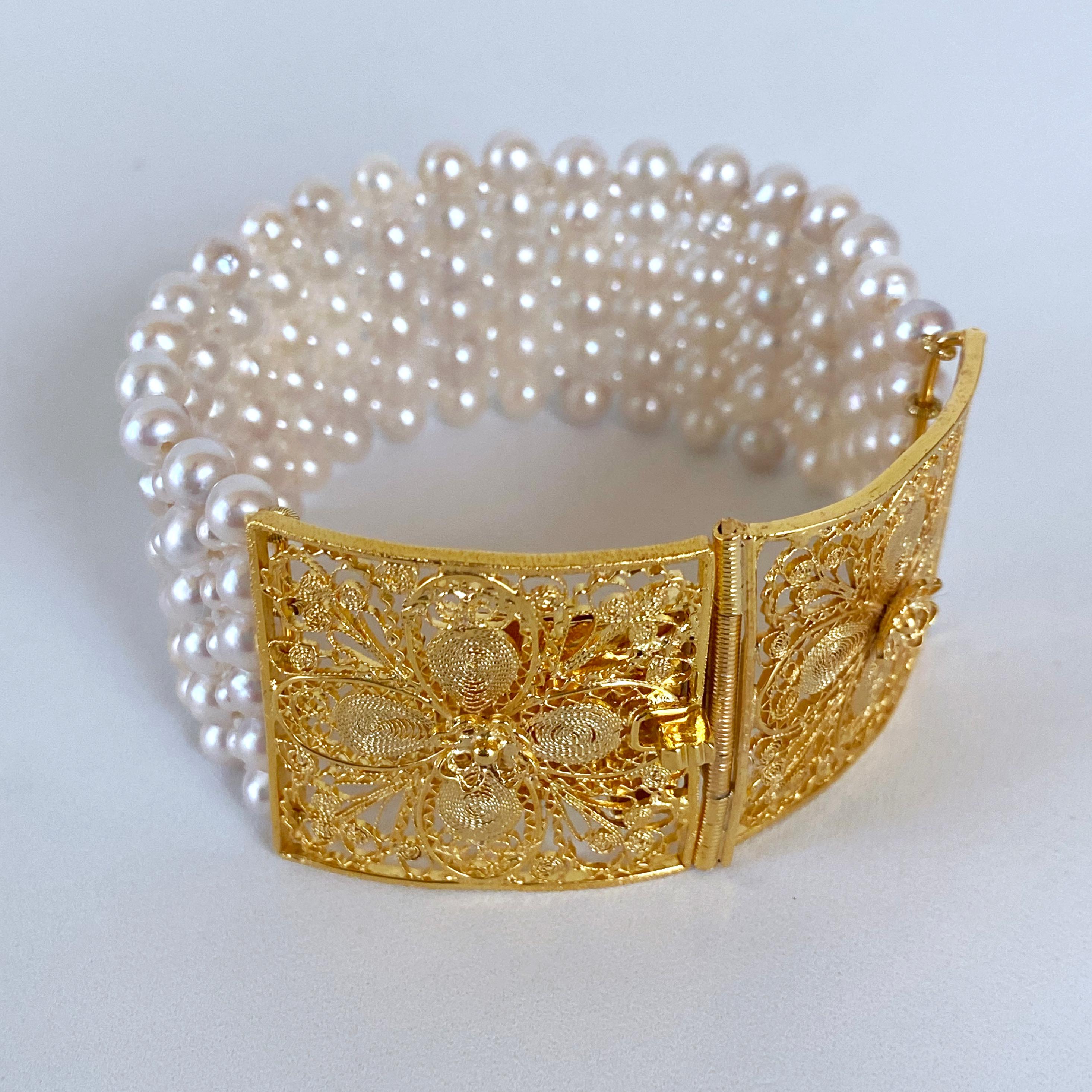 Bold One of A Kind Bracelet by Marina J. This piece features a Vintage Clasp, plated in 18k Yellow Gold, displaying beautiful Floral Filigree detailings. The Clasp is made of two segments that come together to become a vivid Centerpiece. Measuring