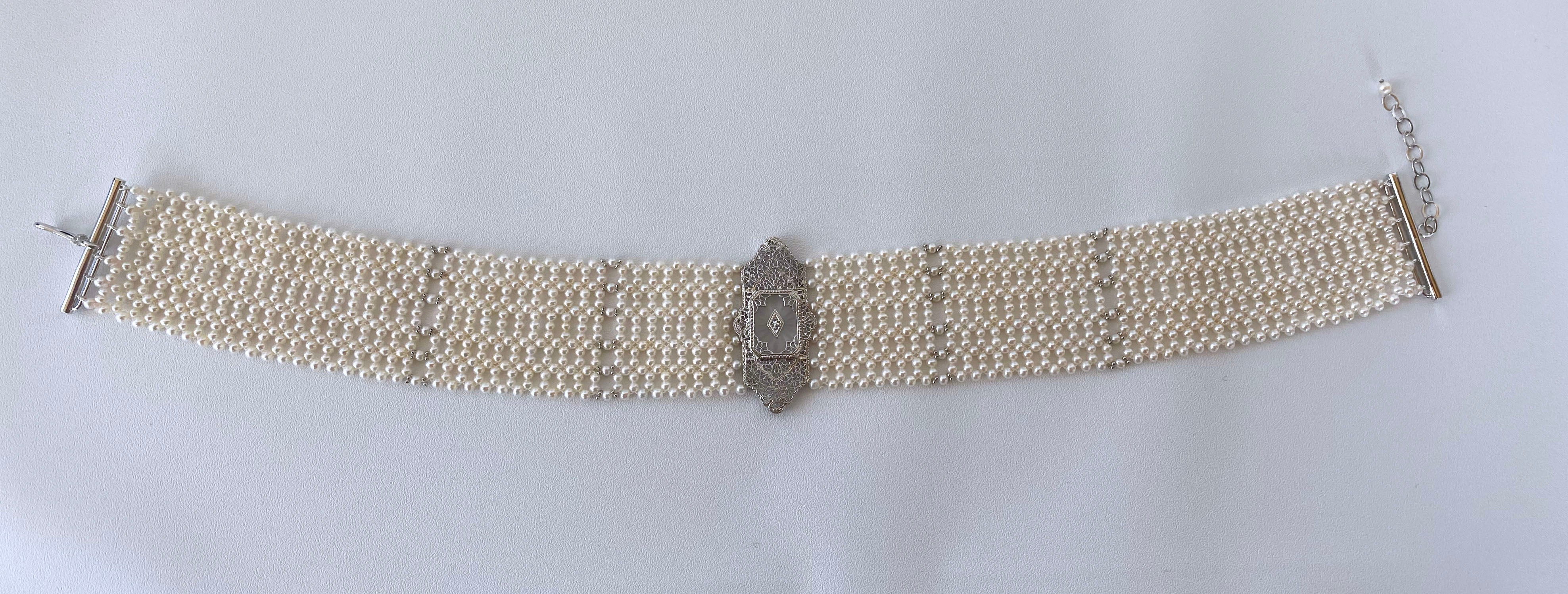Gorgeous hand woven Pearl choker by Marina J. This lovely piece features a beautiful one of a kind Vintage 14k White Gold Brooch reworked and re imagined into a Centerpiece. The Centerpiece displays fine lace detailing and a beautiful small Diamond