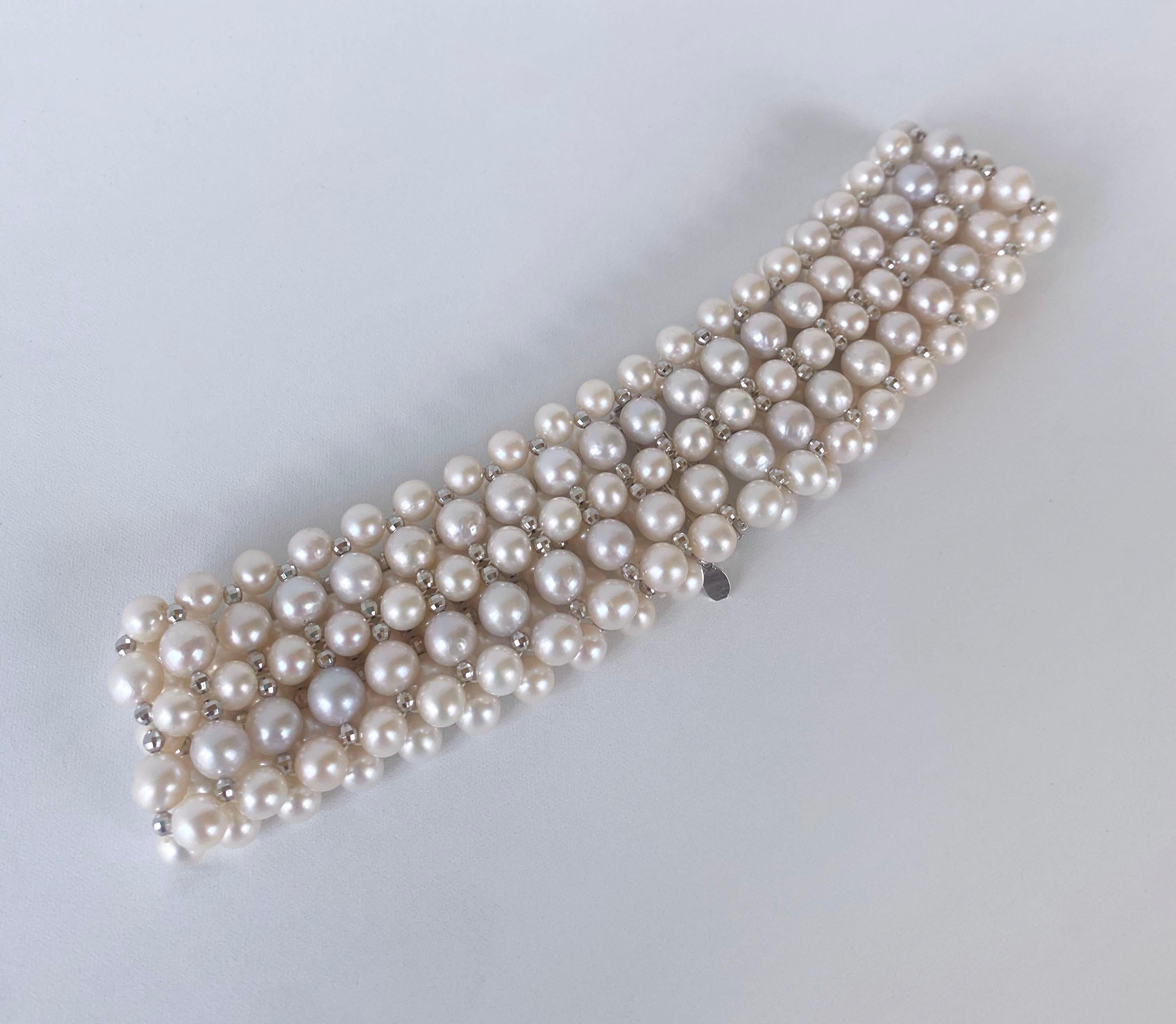 This beautiful choker features high luster White Pearls which display a wonderful sheen, all woven together into a beautiful design. Faceted, White Gold Plated Silver beads are woven between Pearls, adorning this necklace with a great and dramatic