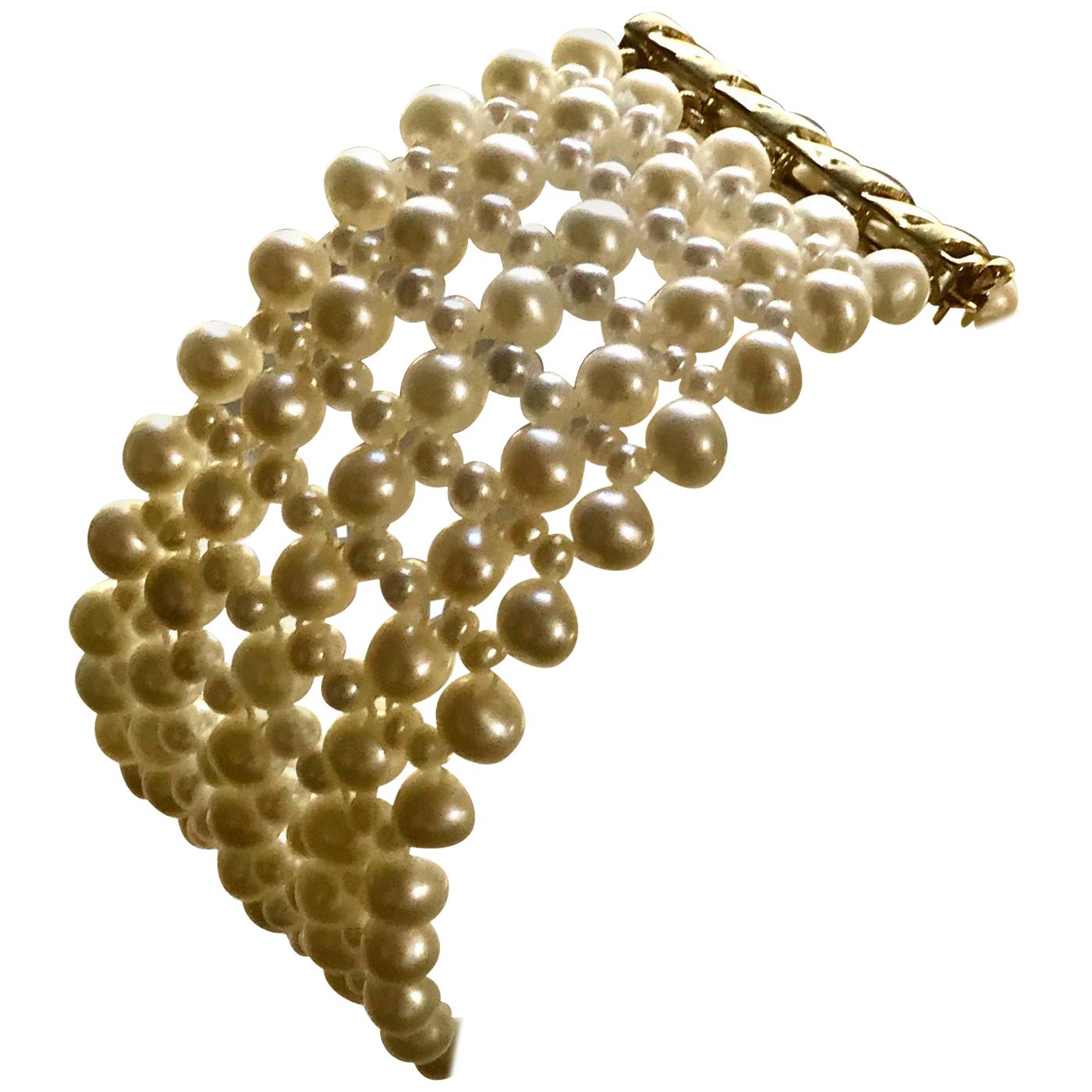 This beautiful, classic, and timeless bracelet has elegant lace-like pearls weave. At a 1 inch wide the different size pearls (4mm to 2mm) create a lace-like design with the sterling silver yellow gold plated clasp. It is easy to use and secure once