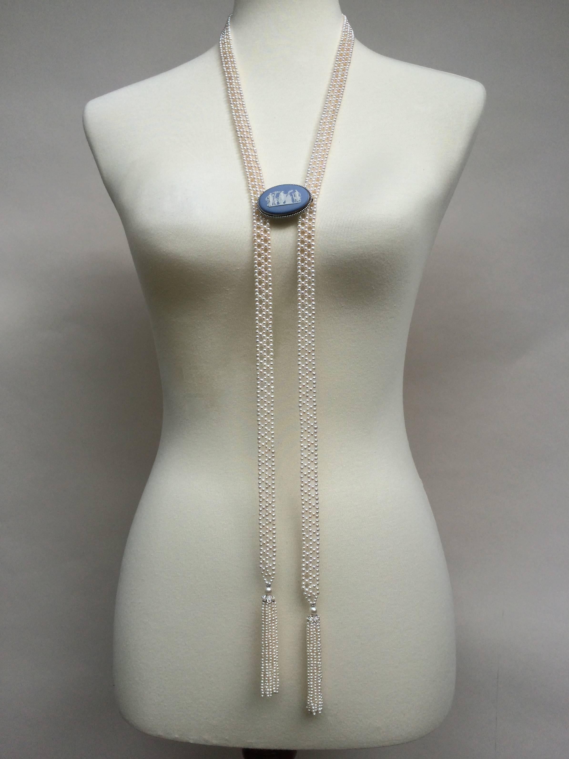 Marina J. presents a unique handmade sautoir necklace, made of small white 2- 2.5 mm pearls and woven into a complex, double lace-like design. The ends of the necklace taper into small pearls, and are complimented by 14 k white gold cups. The lush