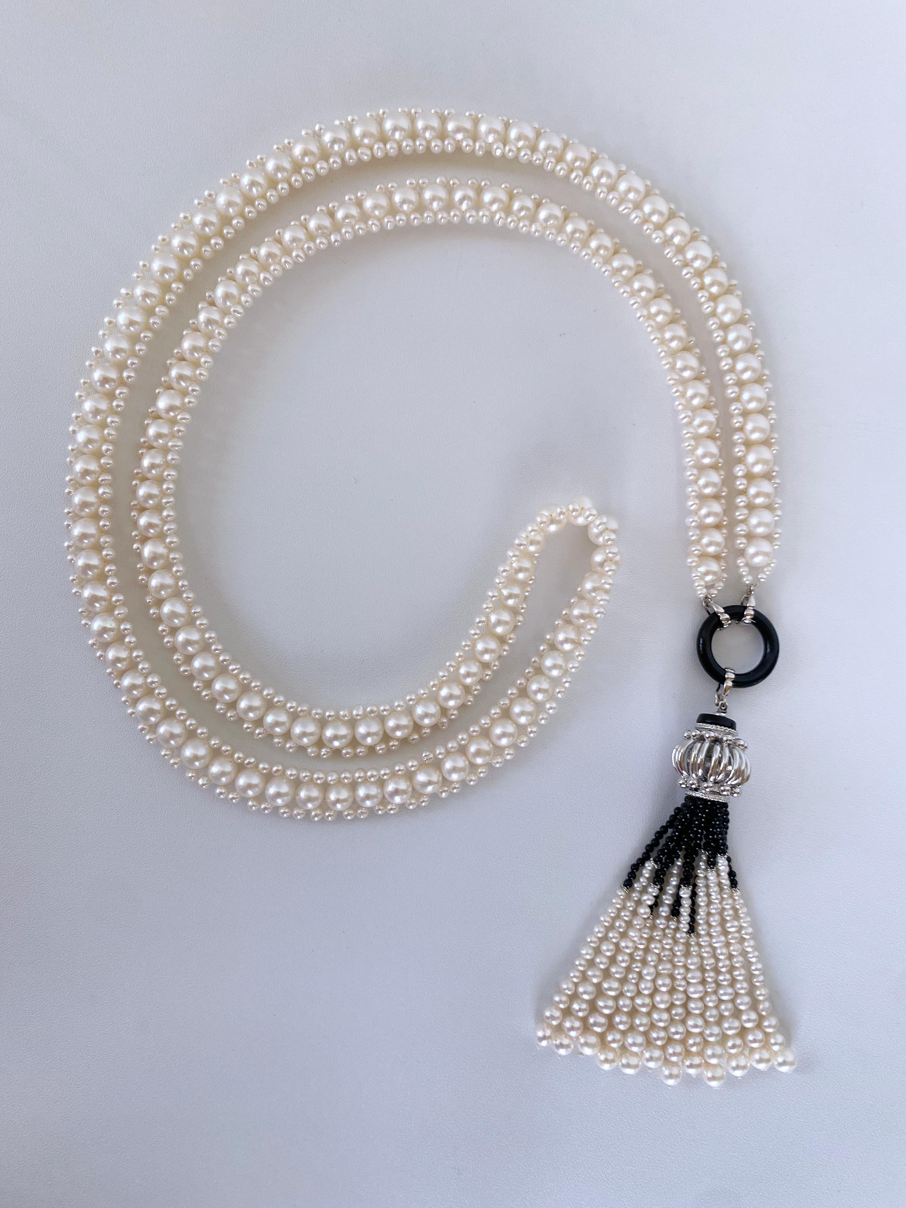 Hand woven piece by Marina J. This stunning Sautoir is made using all White Pearls which feature a wonderful luster and sheen, woven together into a classic design. Measuring 38 inches long sans Tassel, each end of this Sautoir meets at decorative