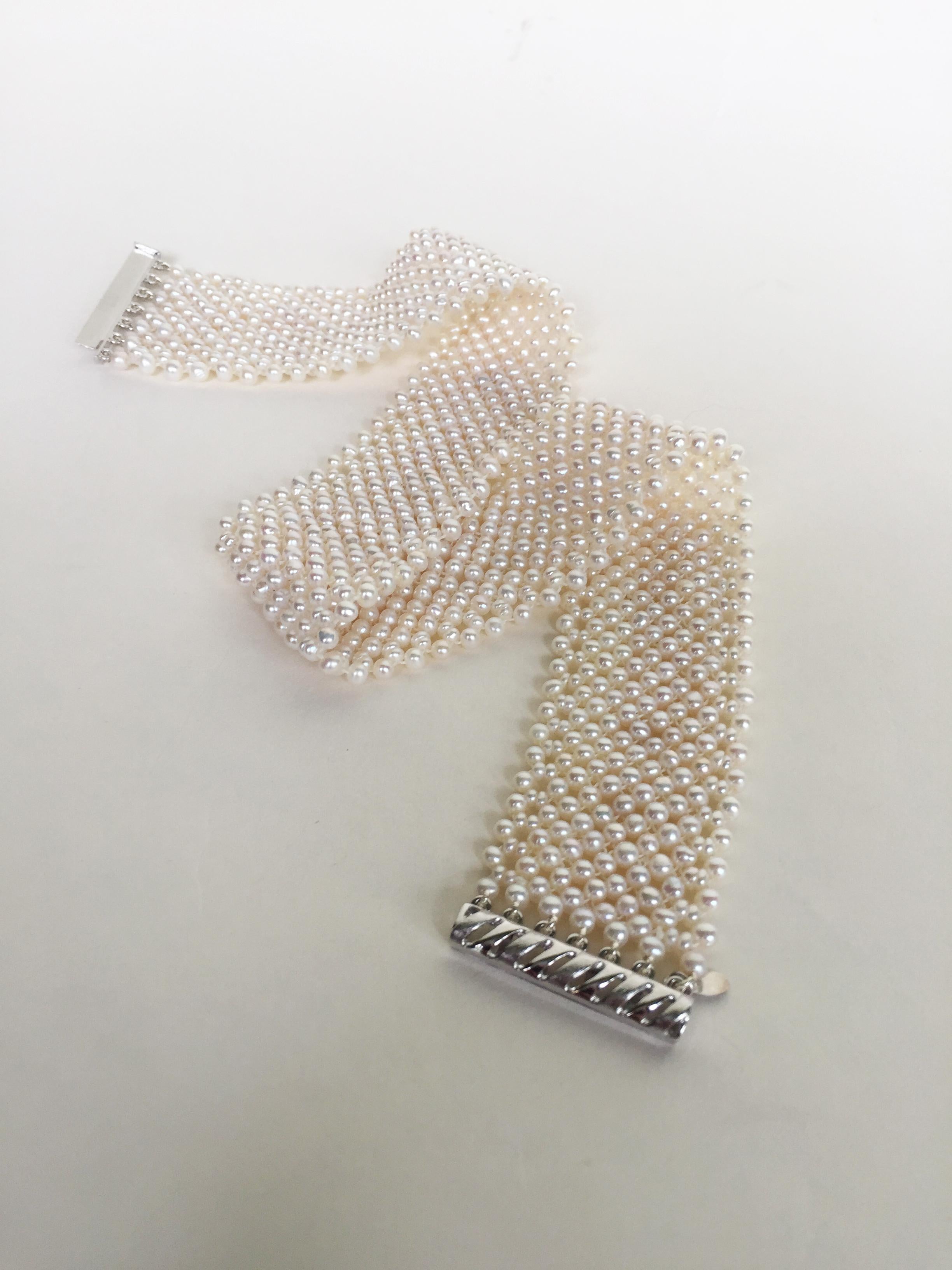 This woven white pearl choker with 14 k white gold sliding clasp is handwoven by Marina J. Each glowing white pearl (2.5-3mm) was handpicked to create an elegant and sophisticated lace-like design. This pearl choker is 1 inch wide and 13 inches long