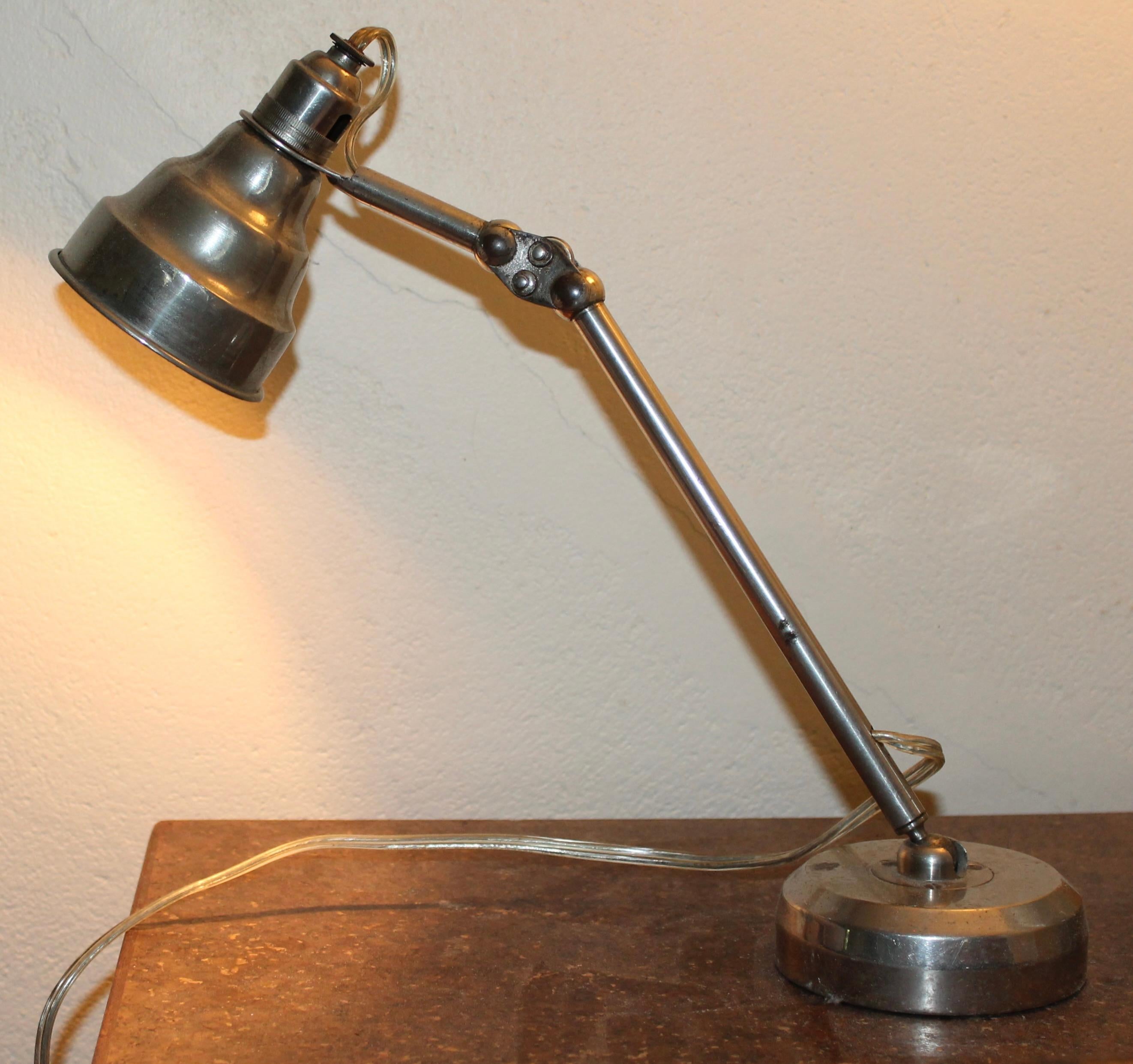 Beautiful little lamp, mostly hand machined in nickel plated brass.
Articulated with ball joints. Heavy (about 6 lbs.) round solid base. A small ask lamp designed  to handle extreme movement. Has been rewired, with a switch on the wire.
