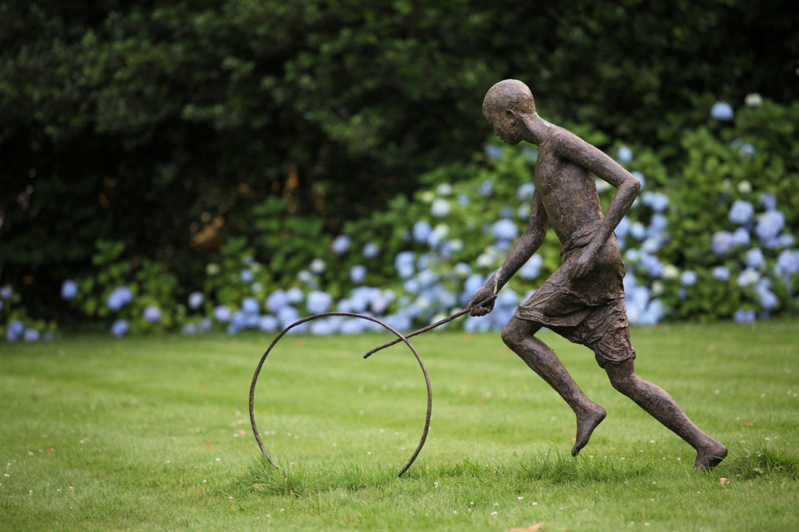 Hoop Rolling Boy by Marine de Soos - Large Outdoor Bronze Sculpture